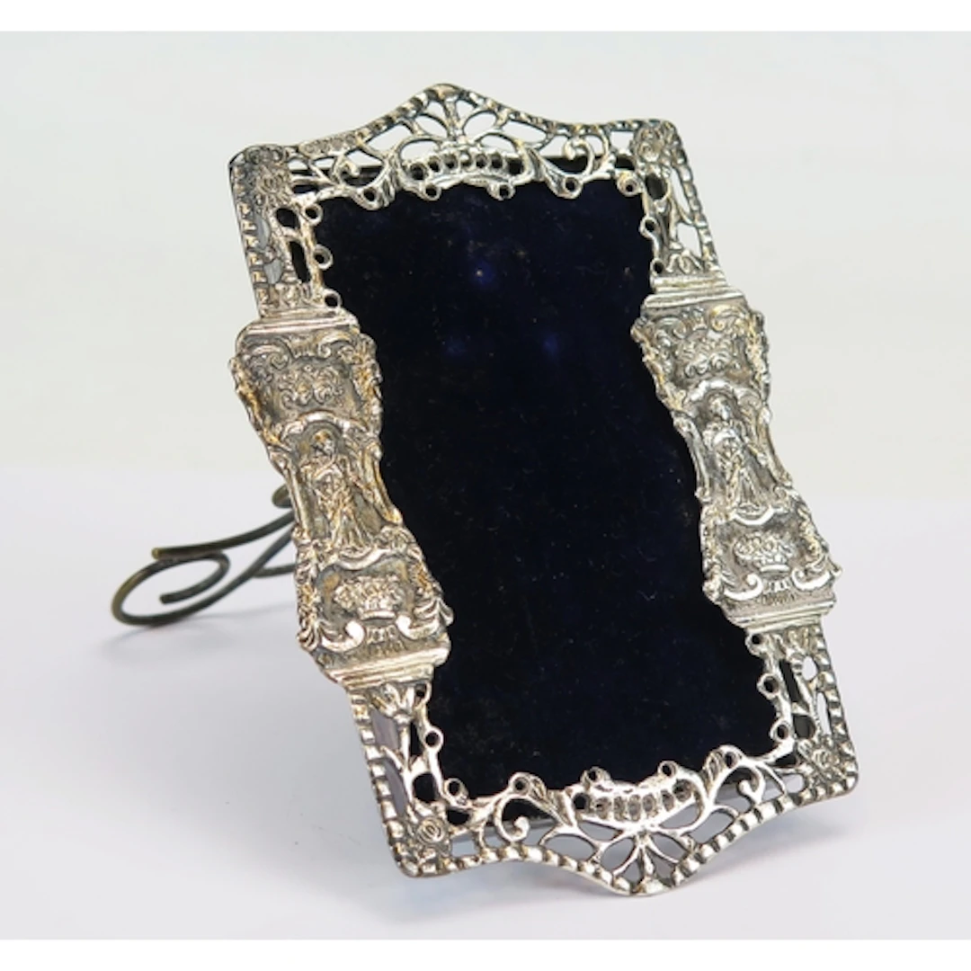 A Victorian silver frame with pierced Classical decoration, ...