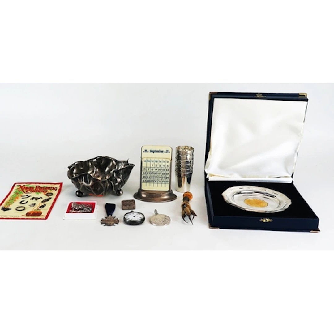 A silver perpetual calendar with ivorine tablets and weighte...