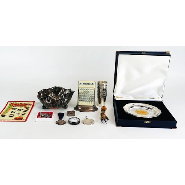 A silver perpetual calendar with ivorine tablets and weighte...