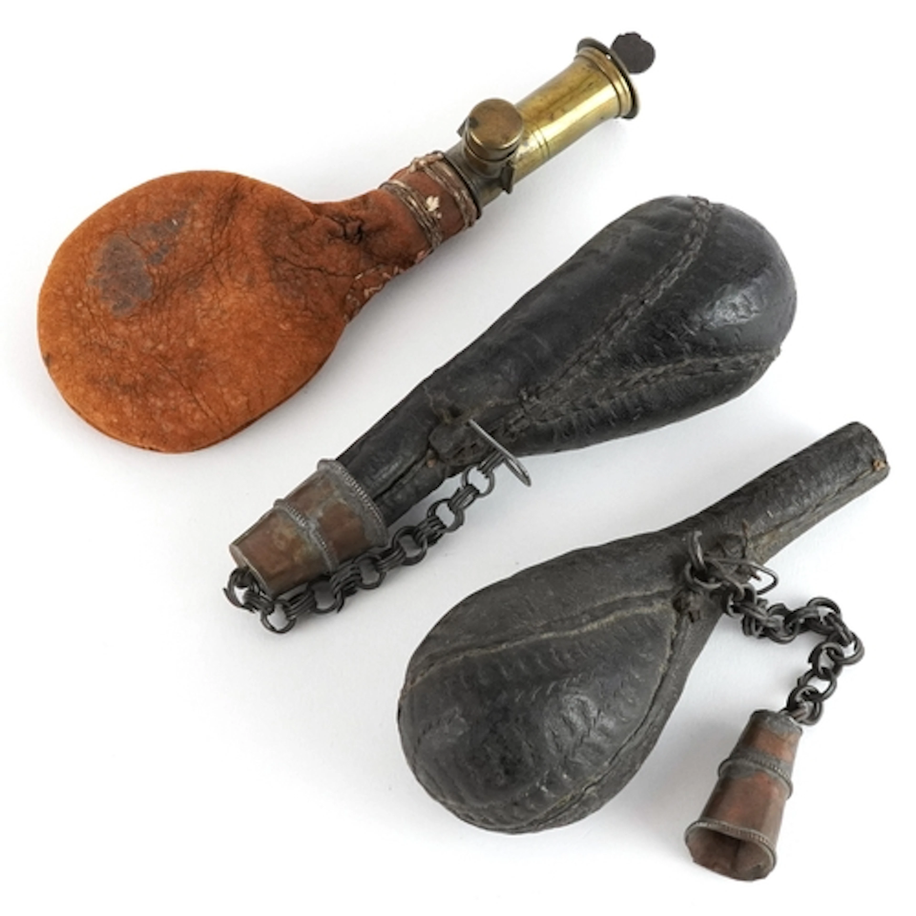 Two antique leather powder flasks, the largest 18cm in lengt...
