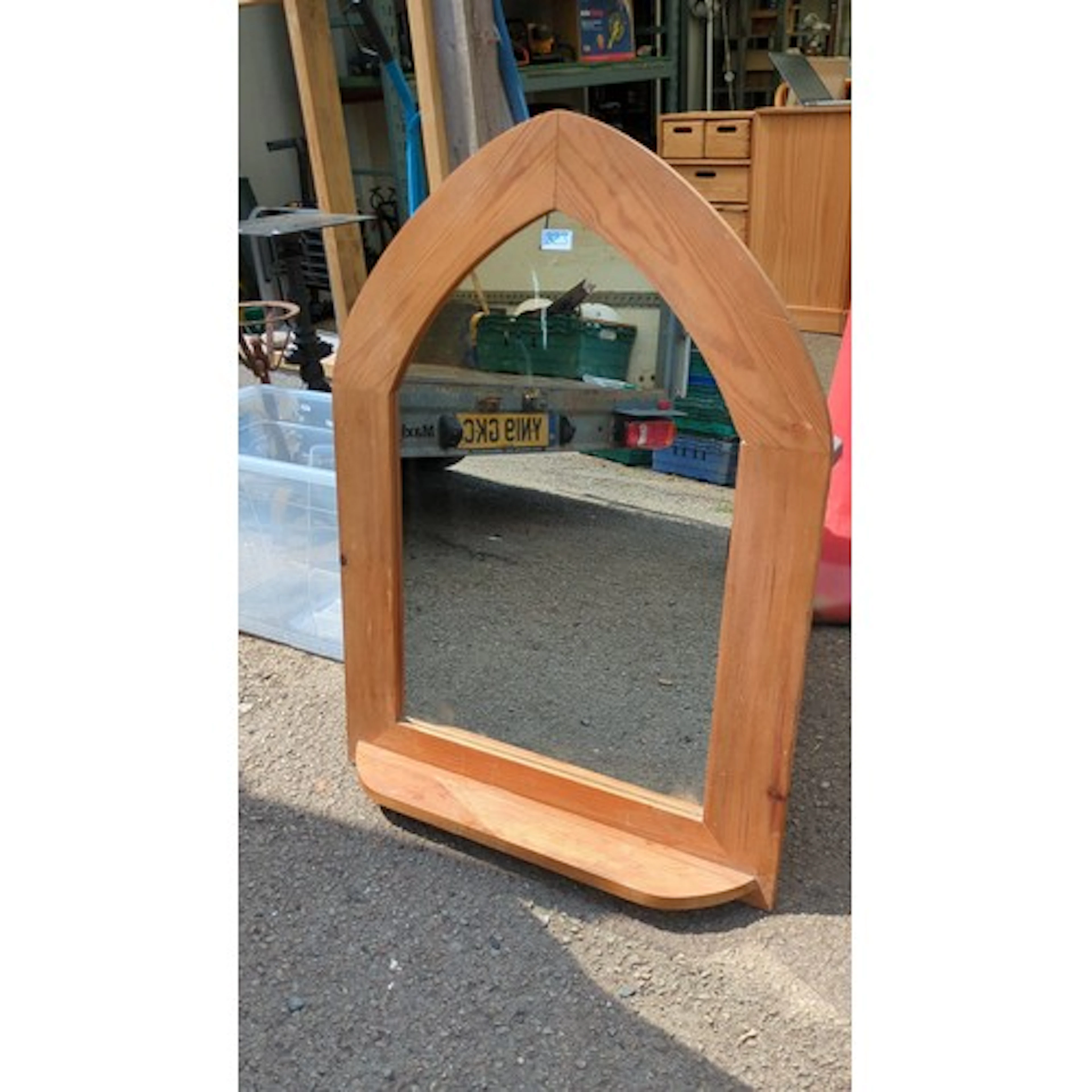 Gothic-arched wall mirror in softwood, the plate beneath a p...