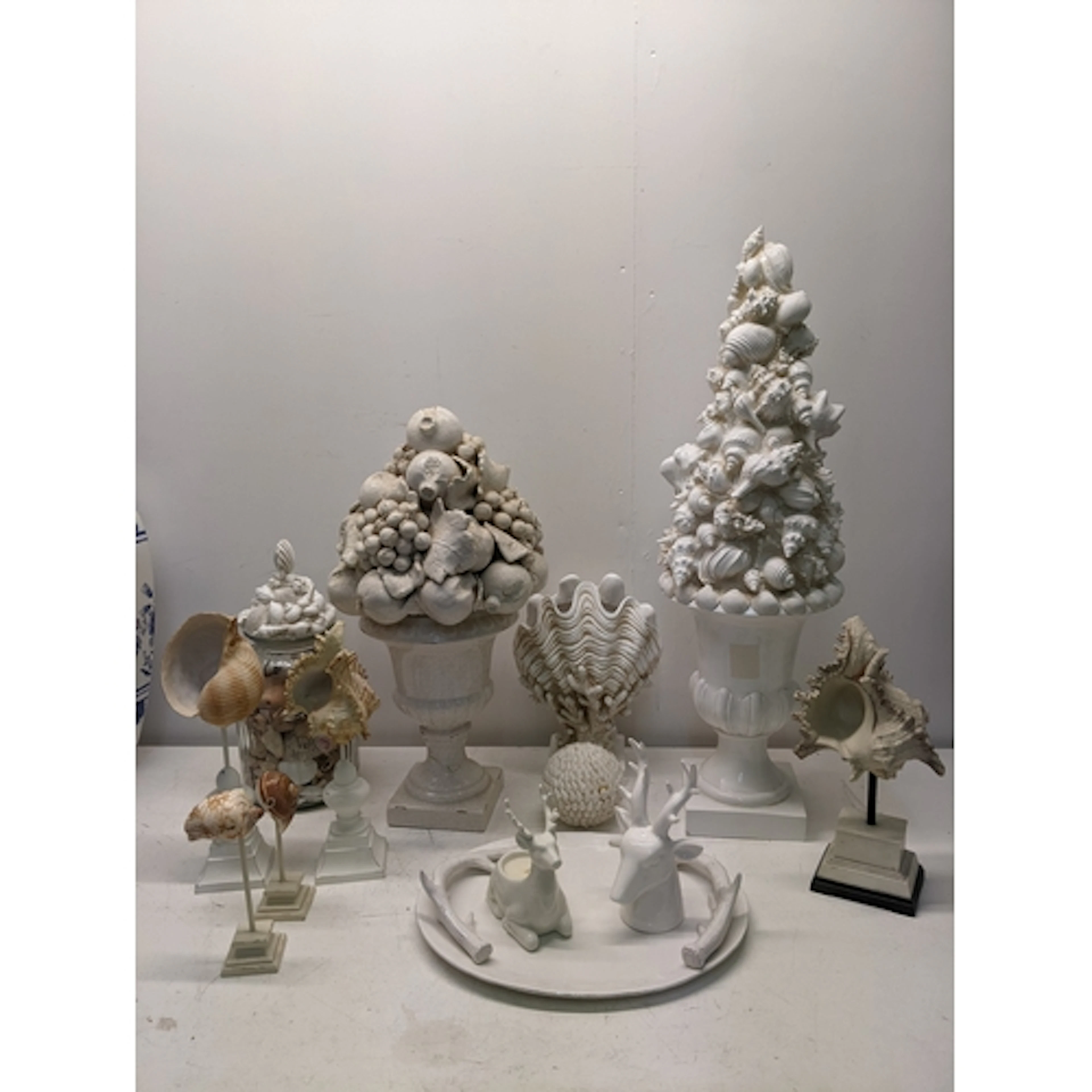 A selection of shell ornaments in ceramic, painted wood, and...