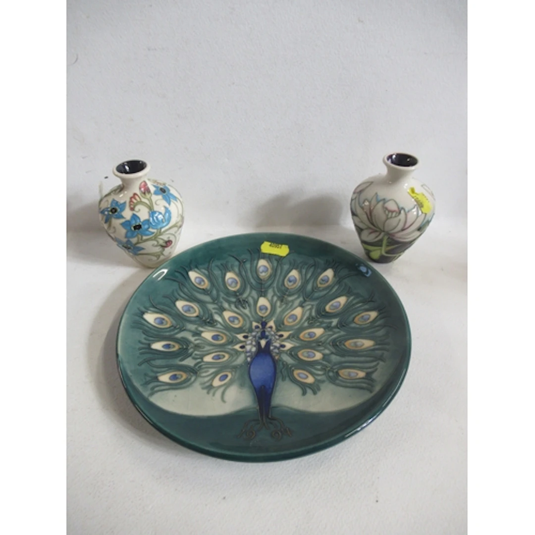 A Moorcroft pottery plate, decorated with a peacock, diamete...
