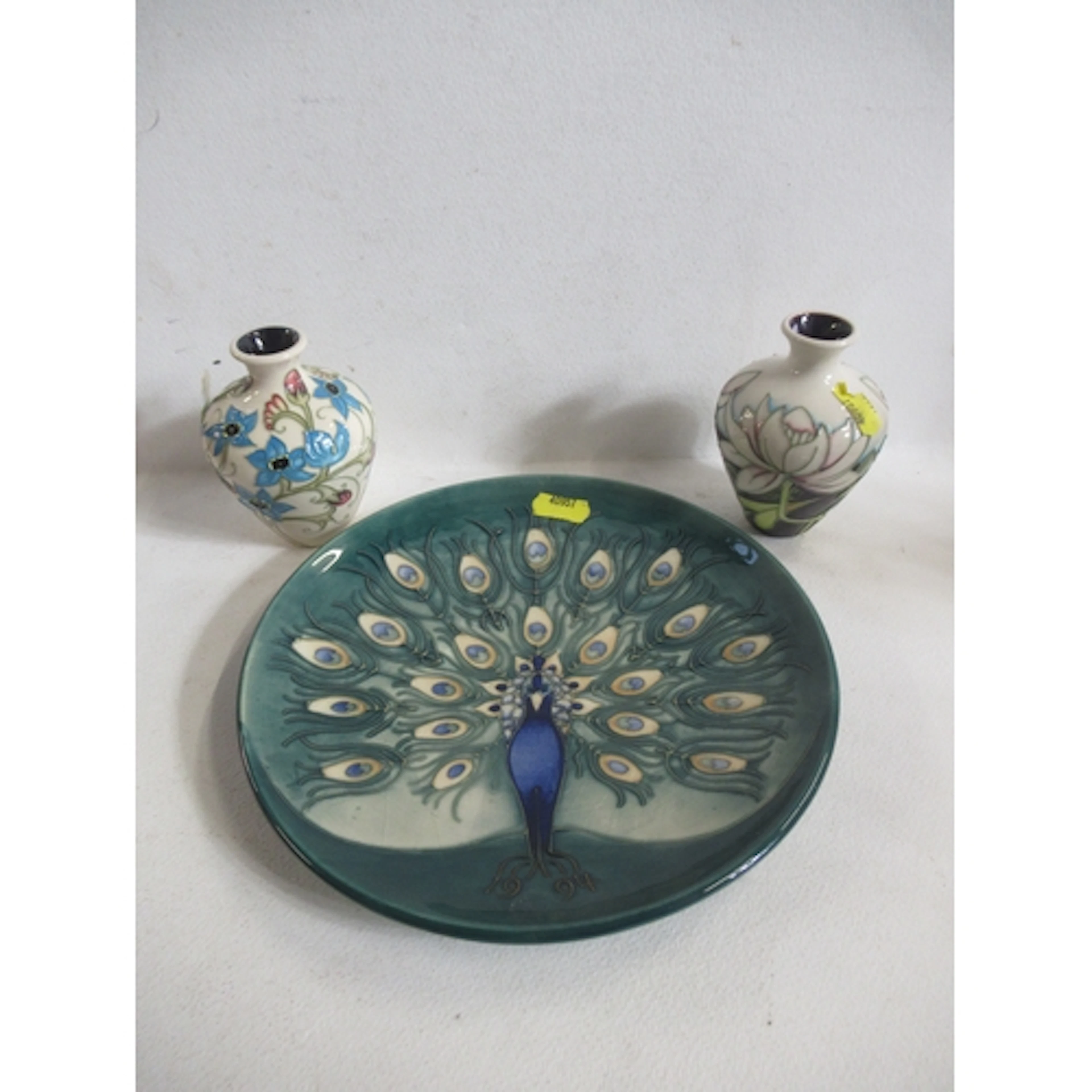 A Moorcroft pottery plate, decorated with a peacock, diamete...