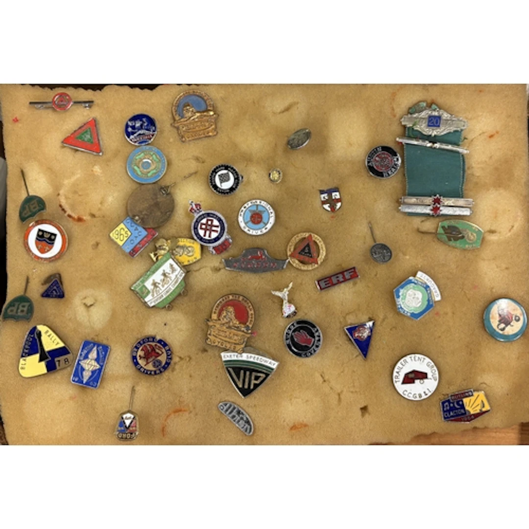 A collection of enamel motoring and other pin badges. Est. £...