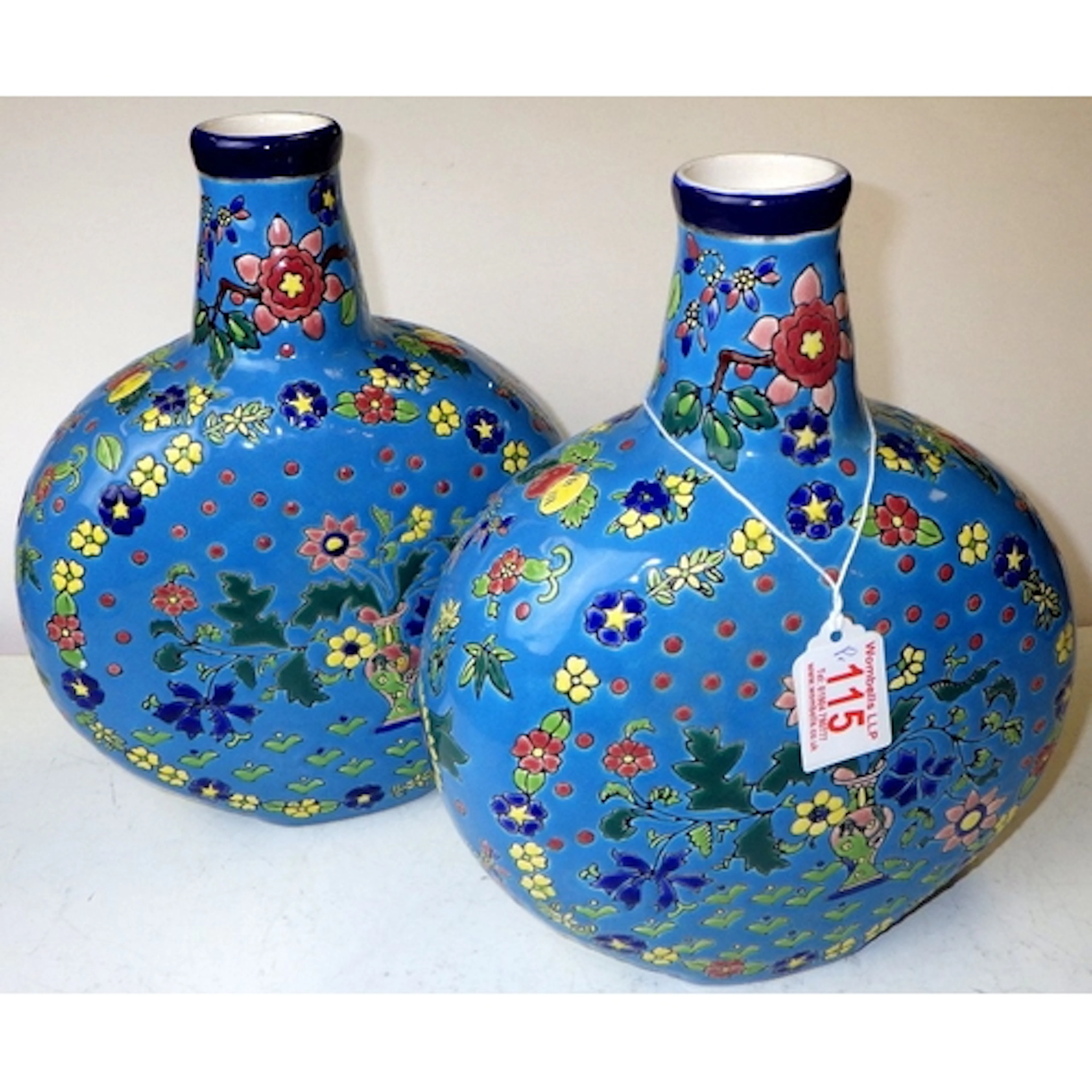 Two turquoise floral ceramic moon vases, 28cm