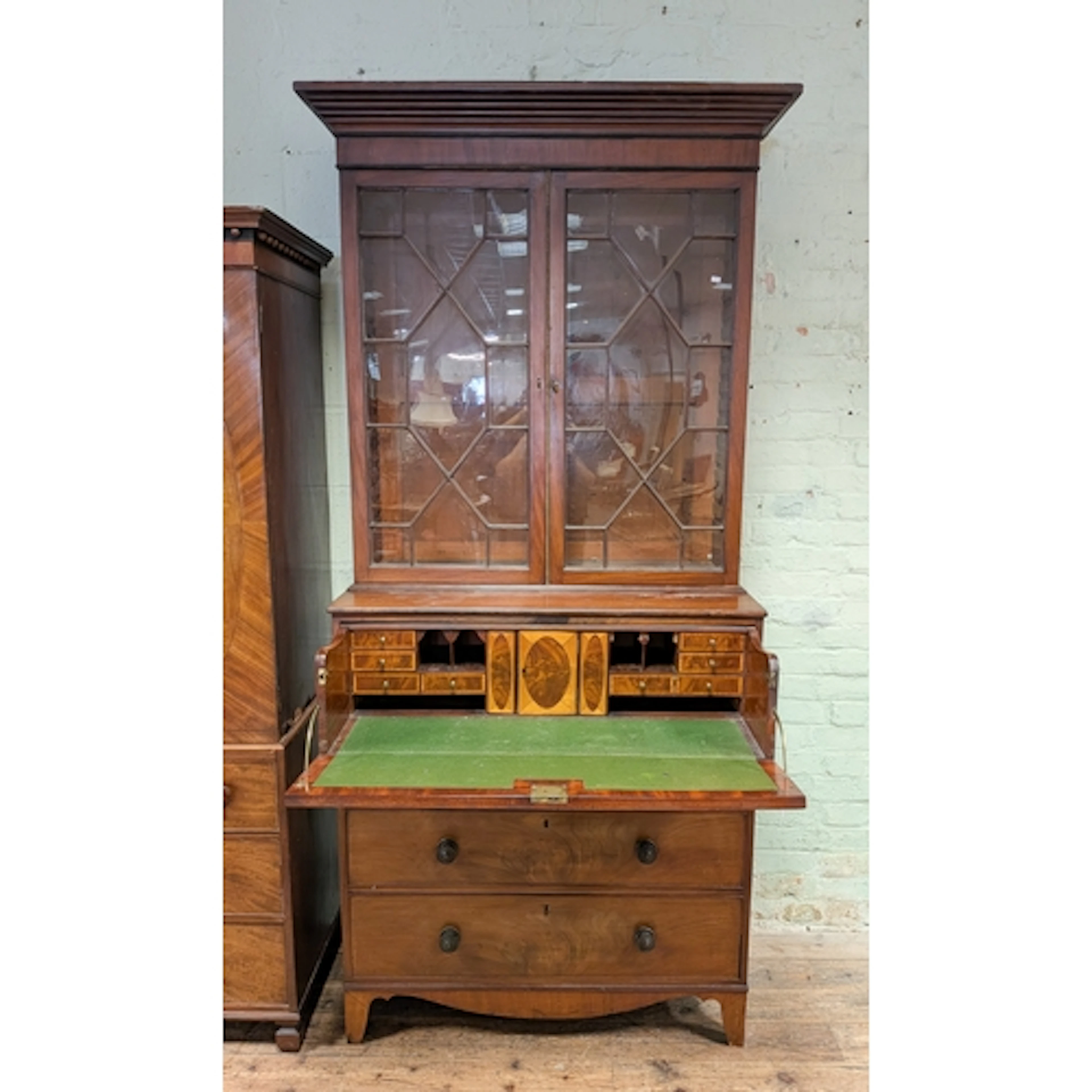 An early 19th century mahogany secretaire bookcase, the top ...