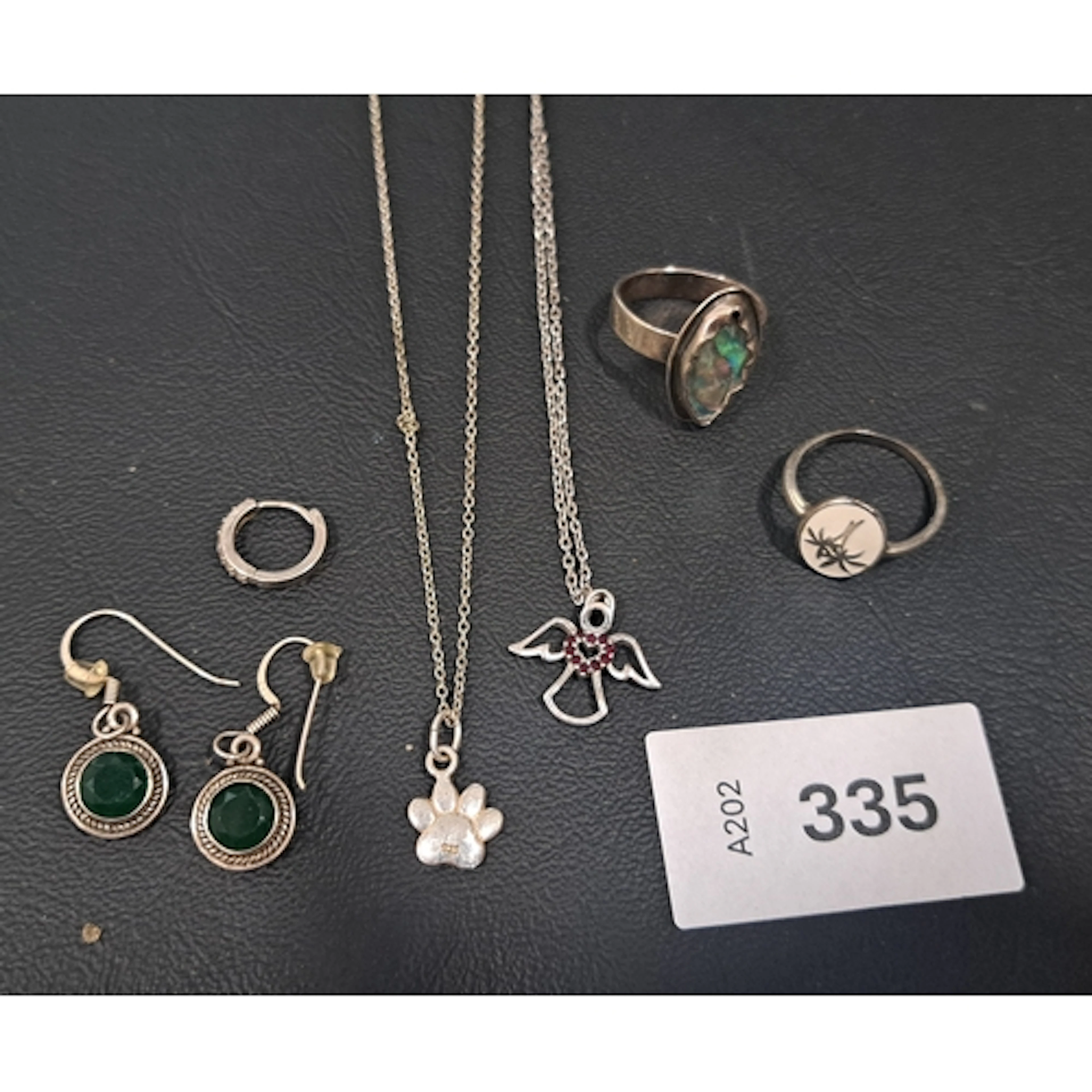 SELECTION OF SILVER JEWELLERY comprising an angel pendant on...