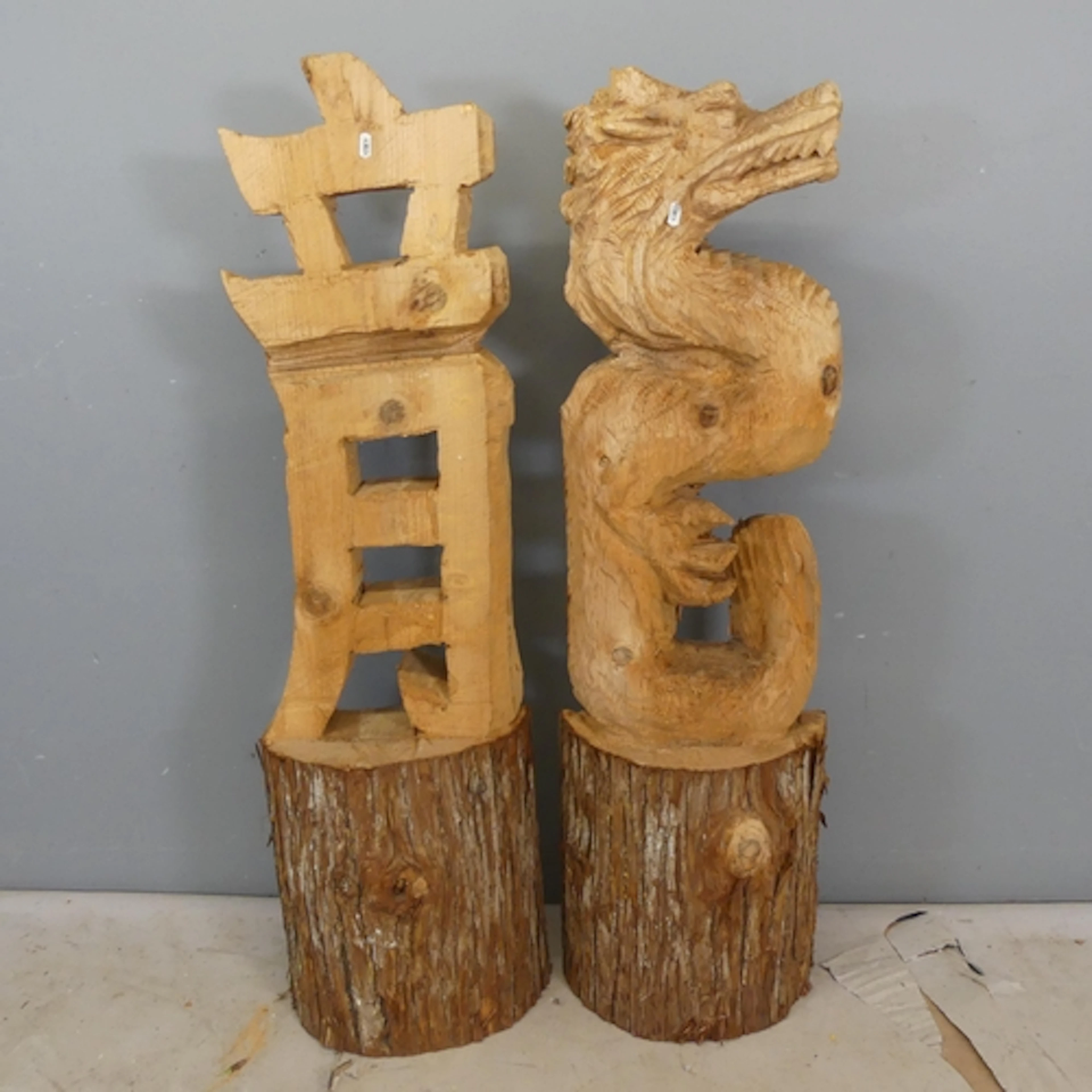 Two Japanese style pine chainsaw sculptures, one depicting a...