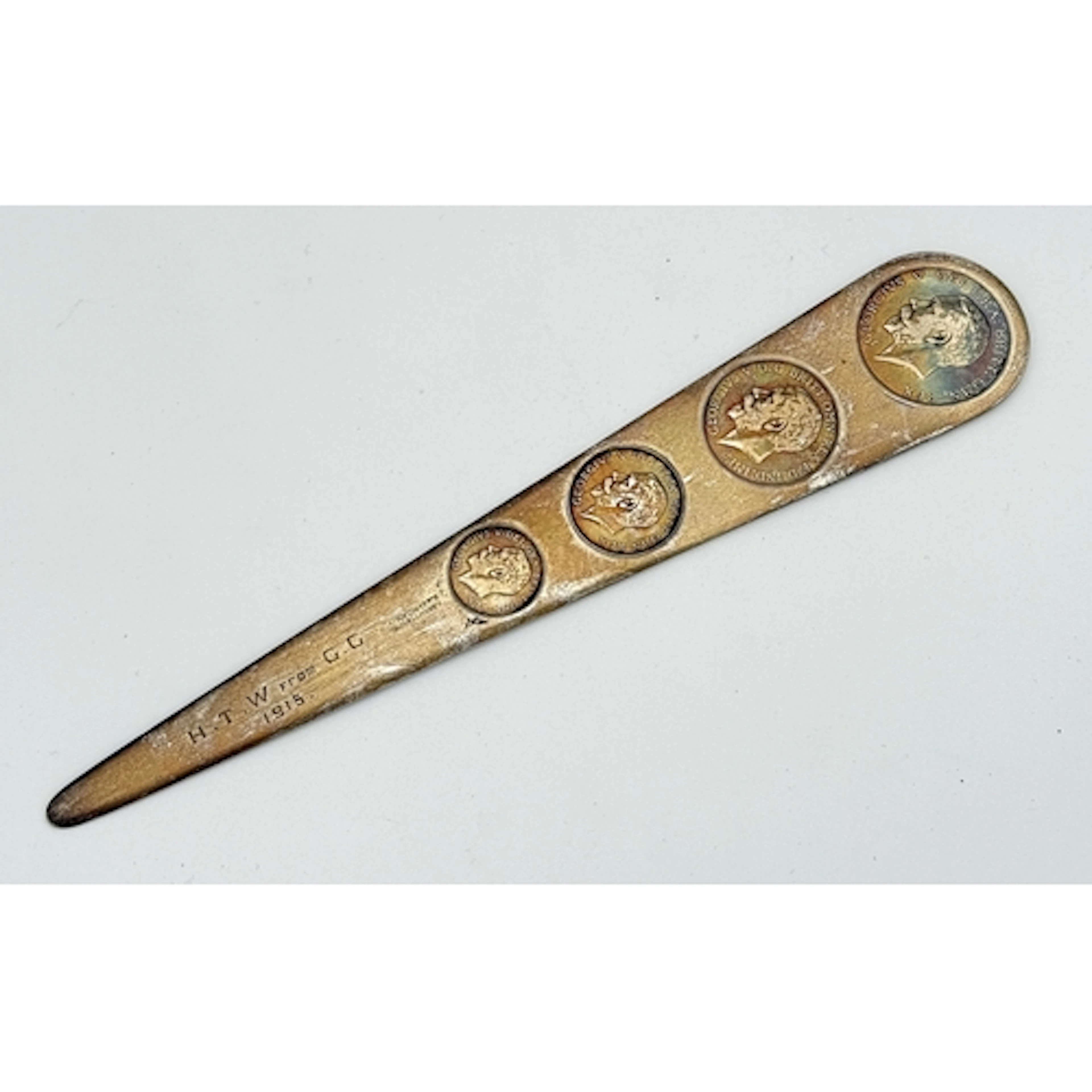A SILVER LETTER OPENER WITH COINS Weight: 84gms...