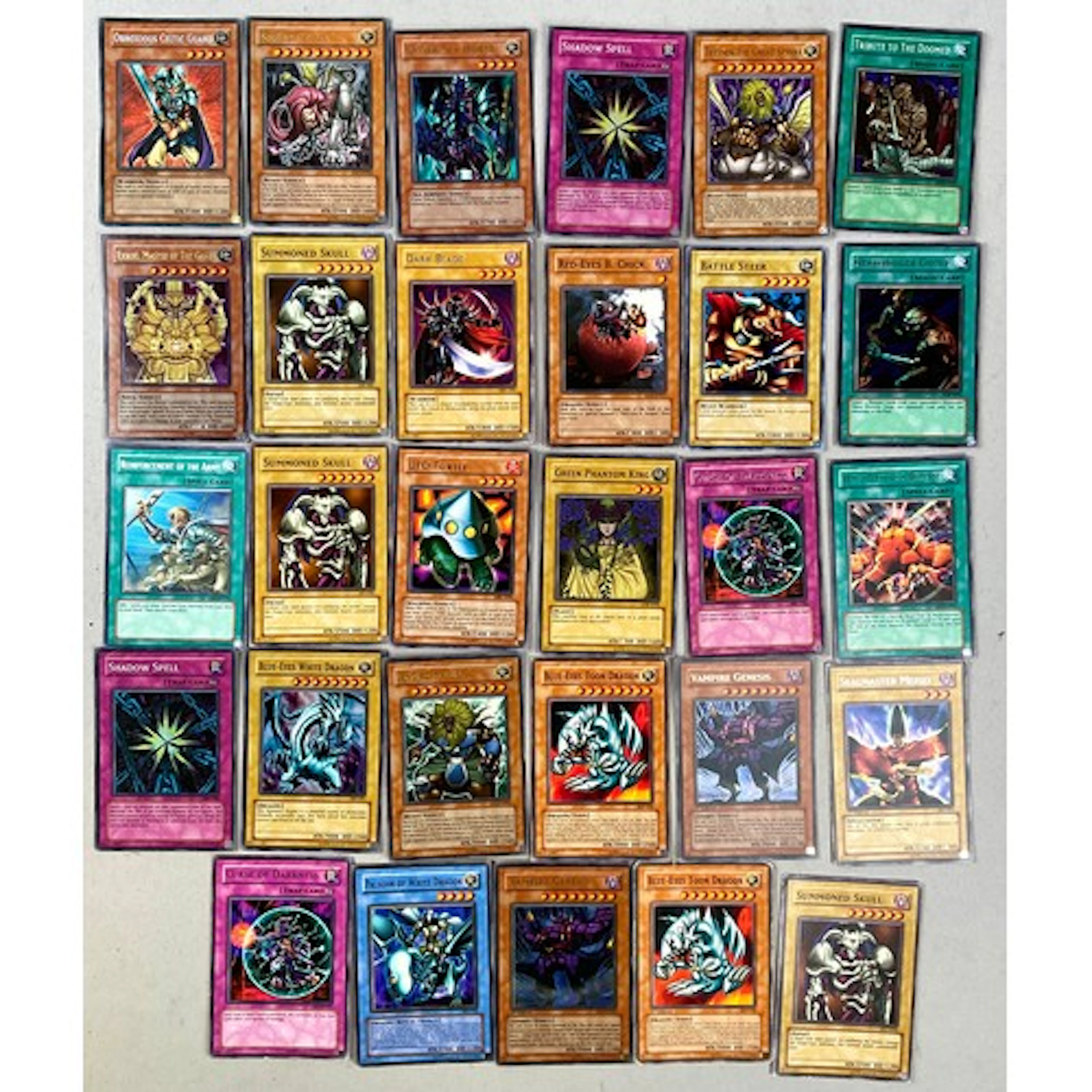 Twenty-nine Yu-Gi-Oh! trading cards, mostly holographic/shin...