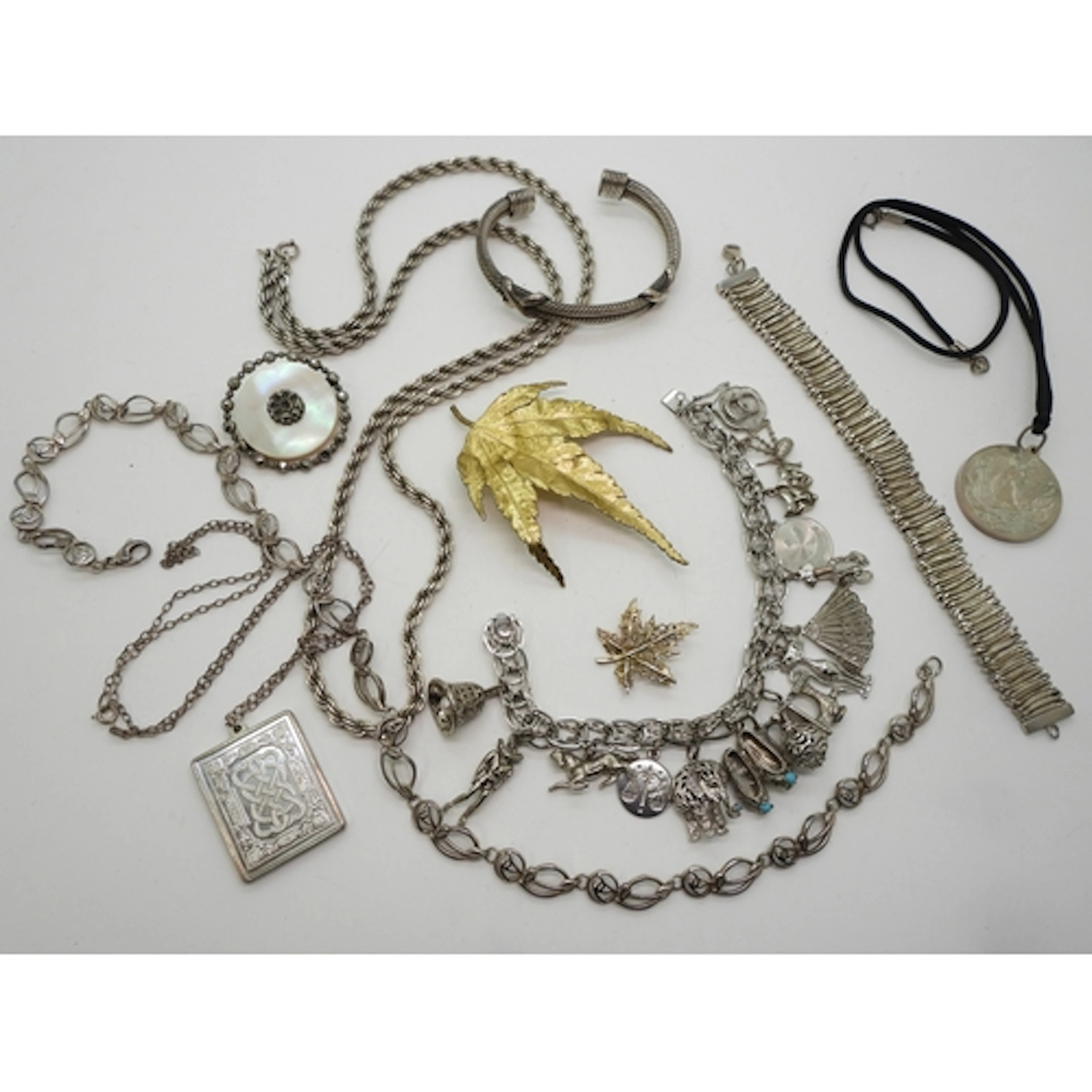 A white metal 1970's charm bracelet with makers mark GAJ mos...
