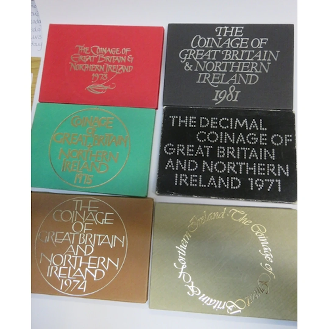 Six cased sets of commemorative coins