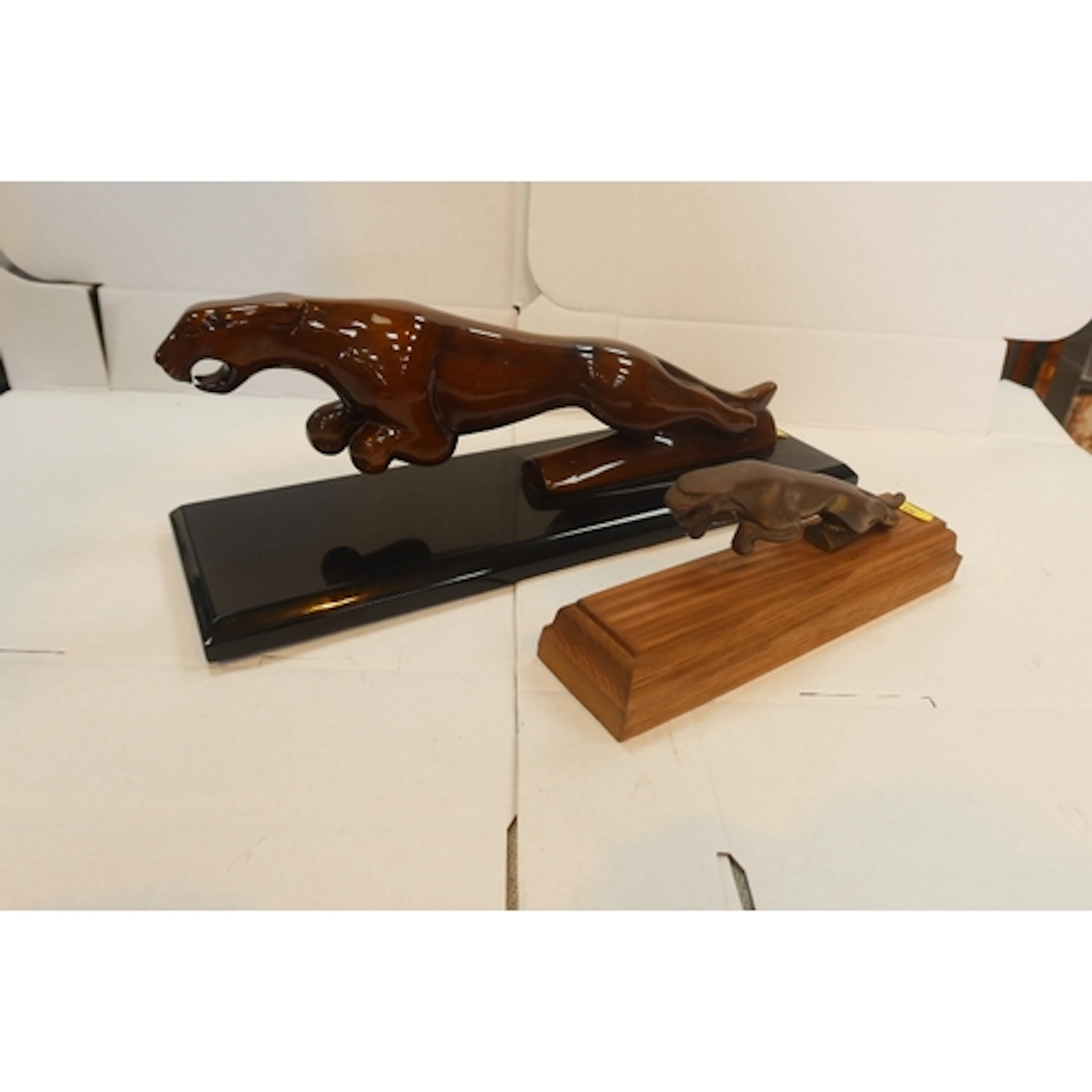 Wooden Jaguar model and a cast Jaguar model