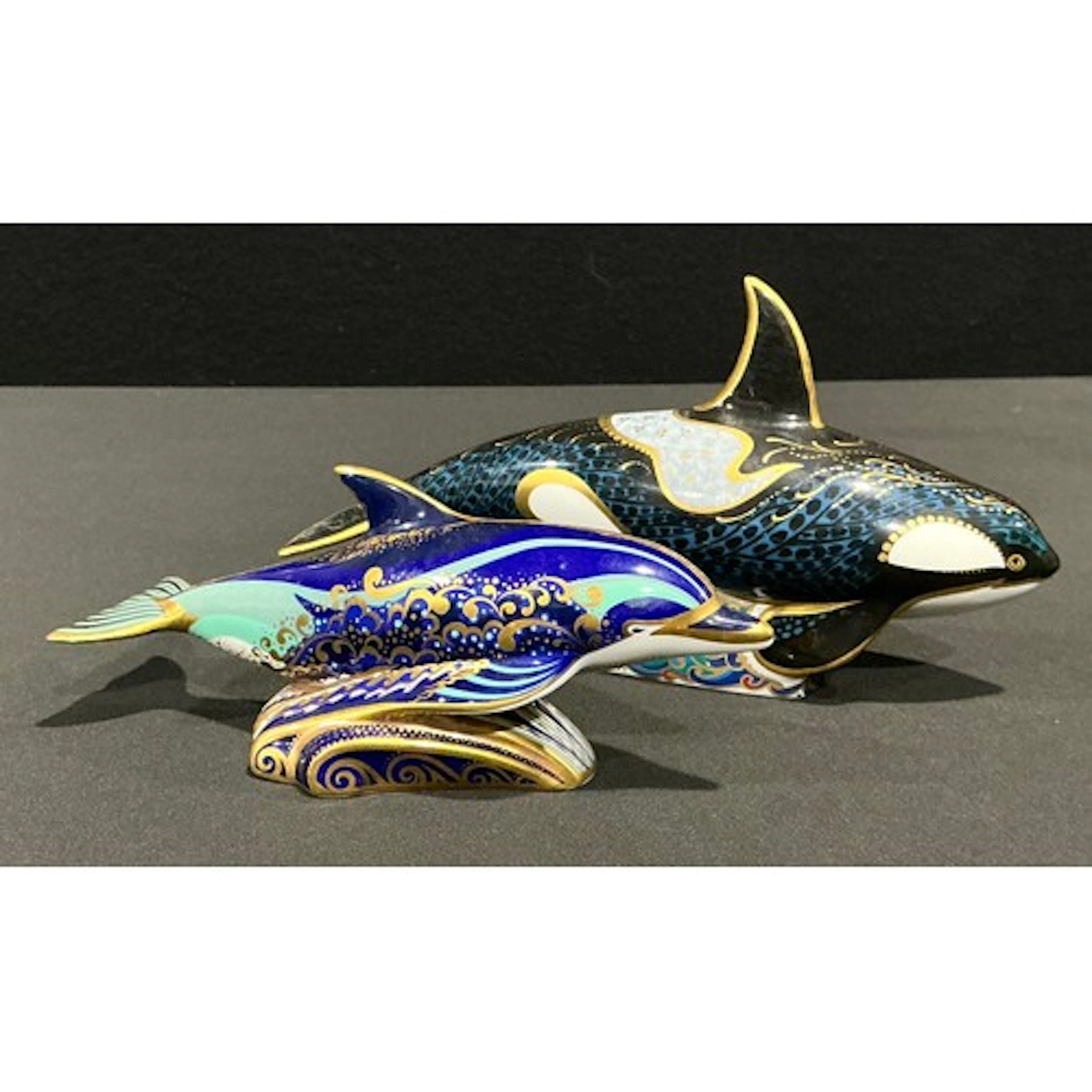 A Royal Crown Derby paperweight, Fair Isle Orca, silver stop...