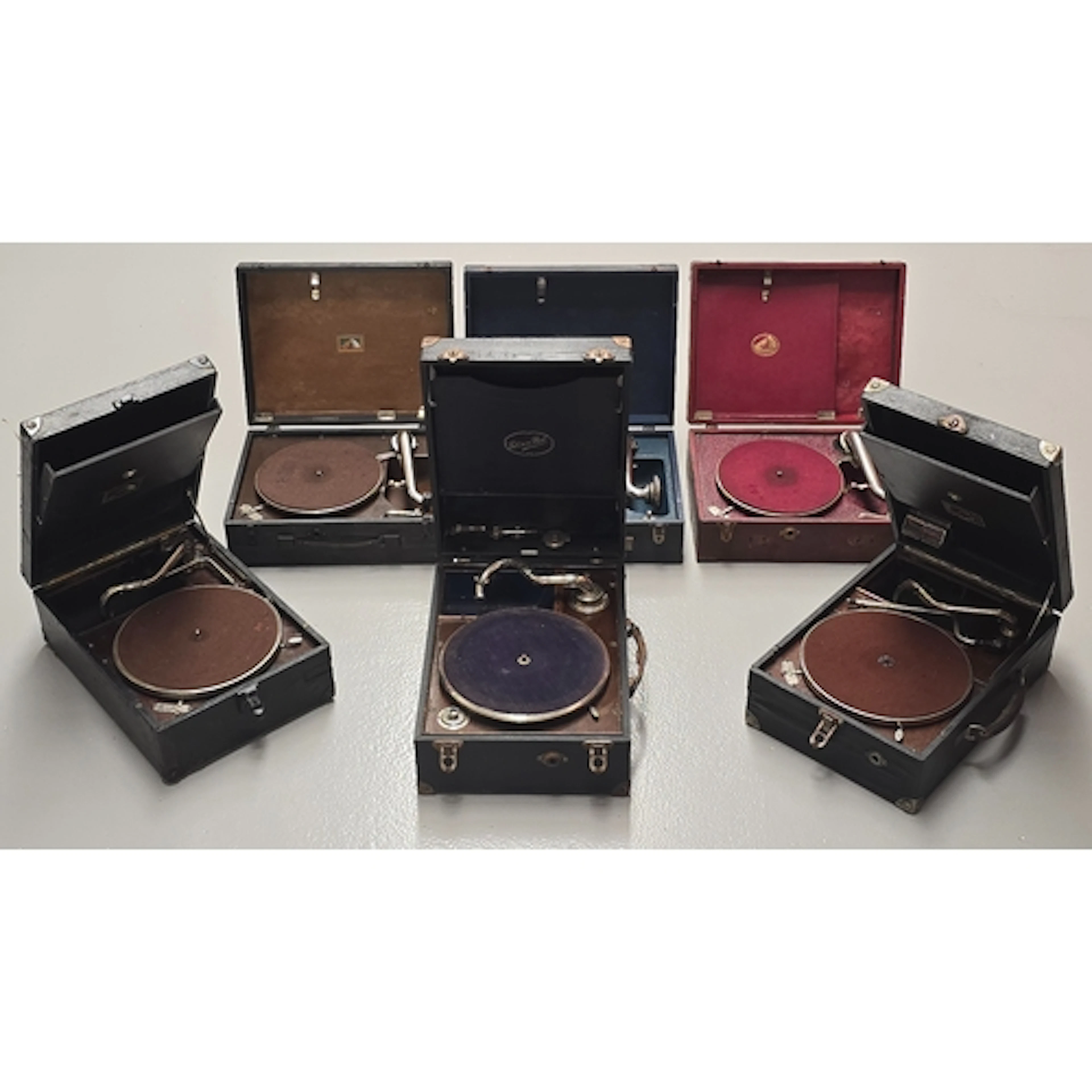 A collection of five HMV portable gramophones together with ...