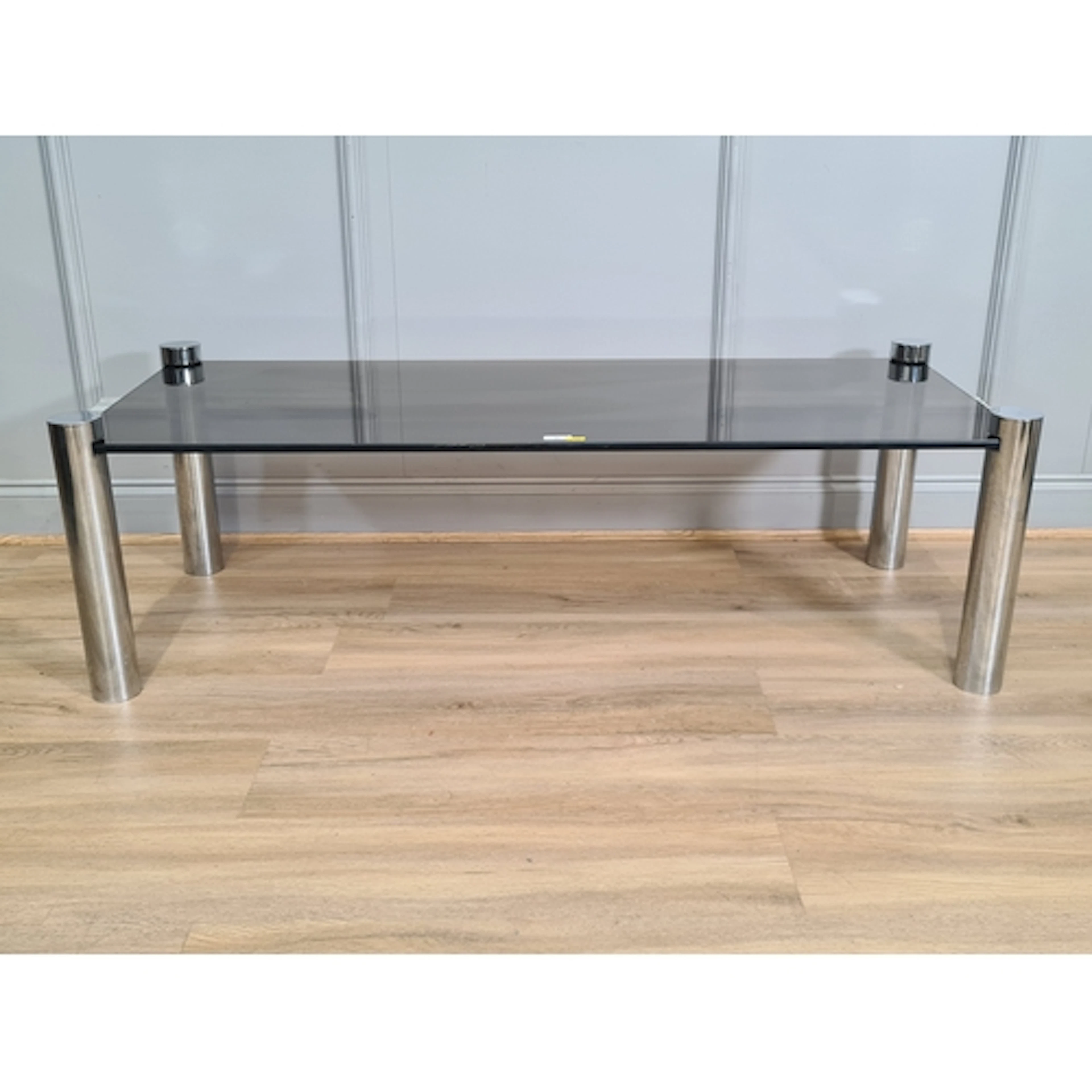 A smoked glass top Coffee Table on tubular metal supports, 4...