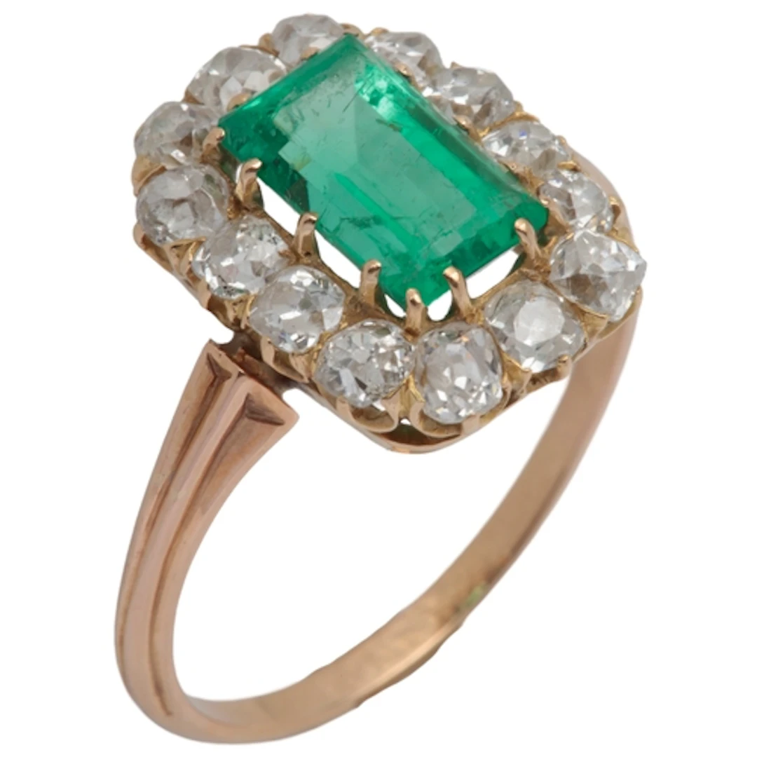 An emerald and diamond ring, 19th century, of cluster design...