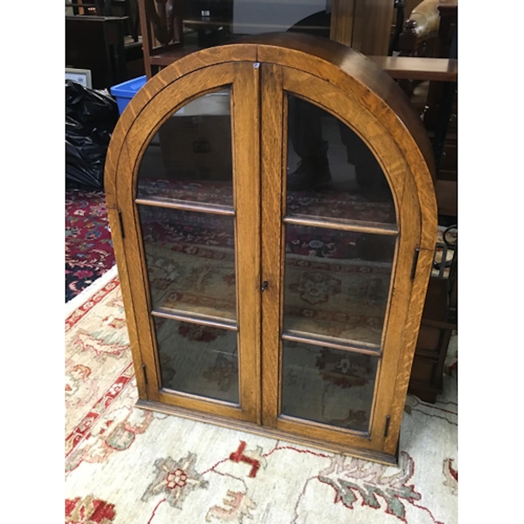 An arched-top oak display cabinet, 78cm tall