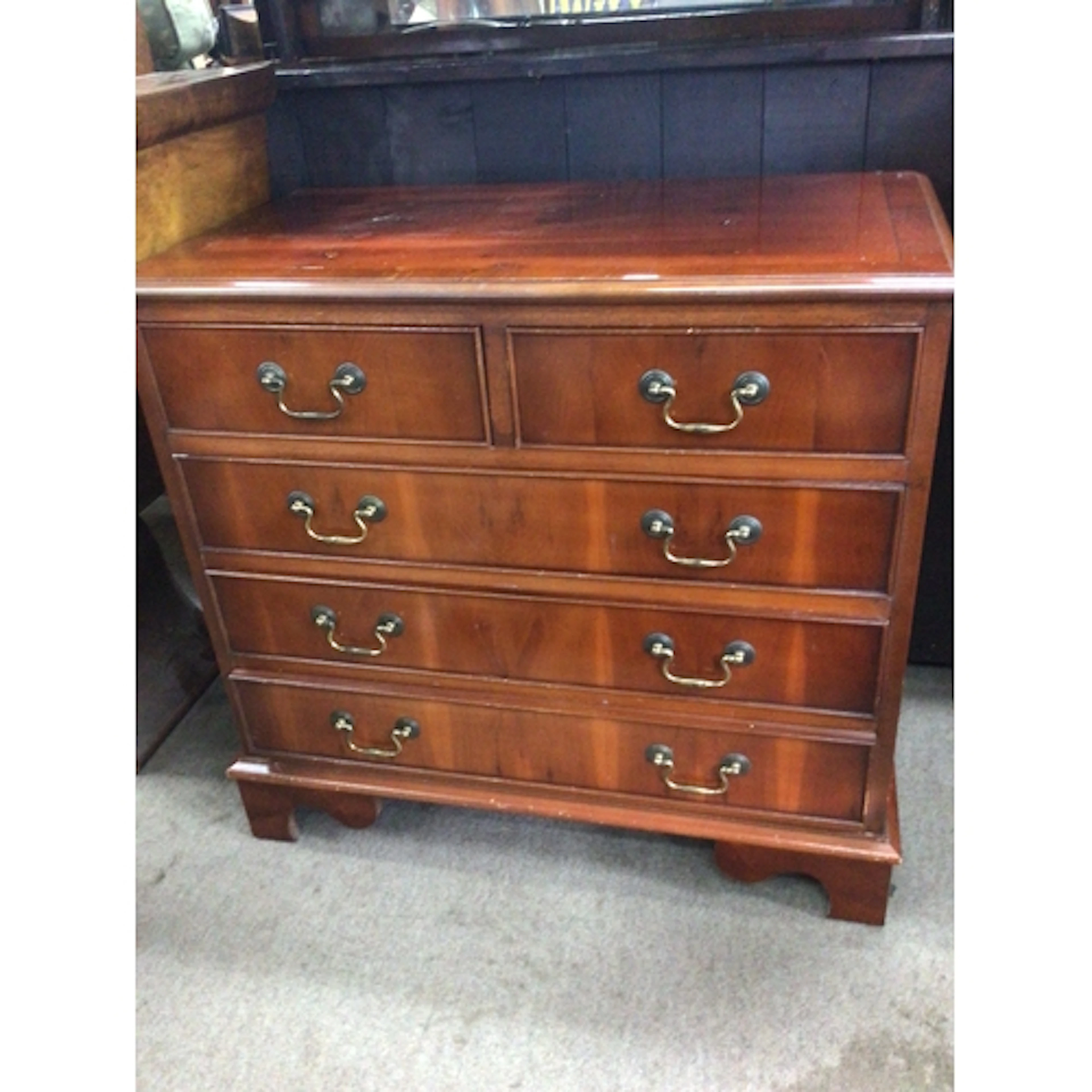 A Yew wood chest of drawers fitted with two short and three ...