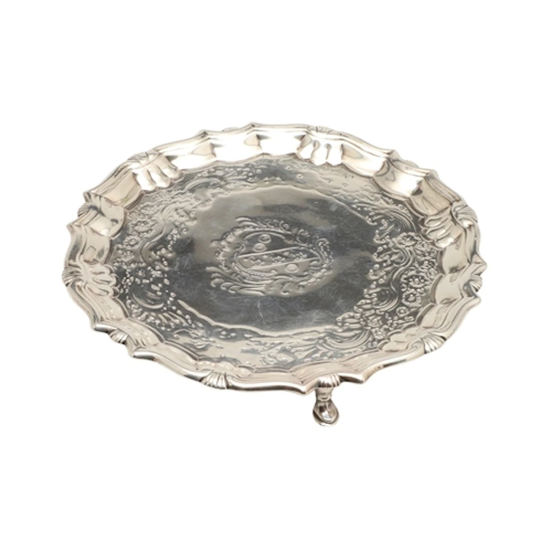 A GEORGE II SILVER WAITER. With cast border, the centre feat...