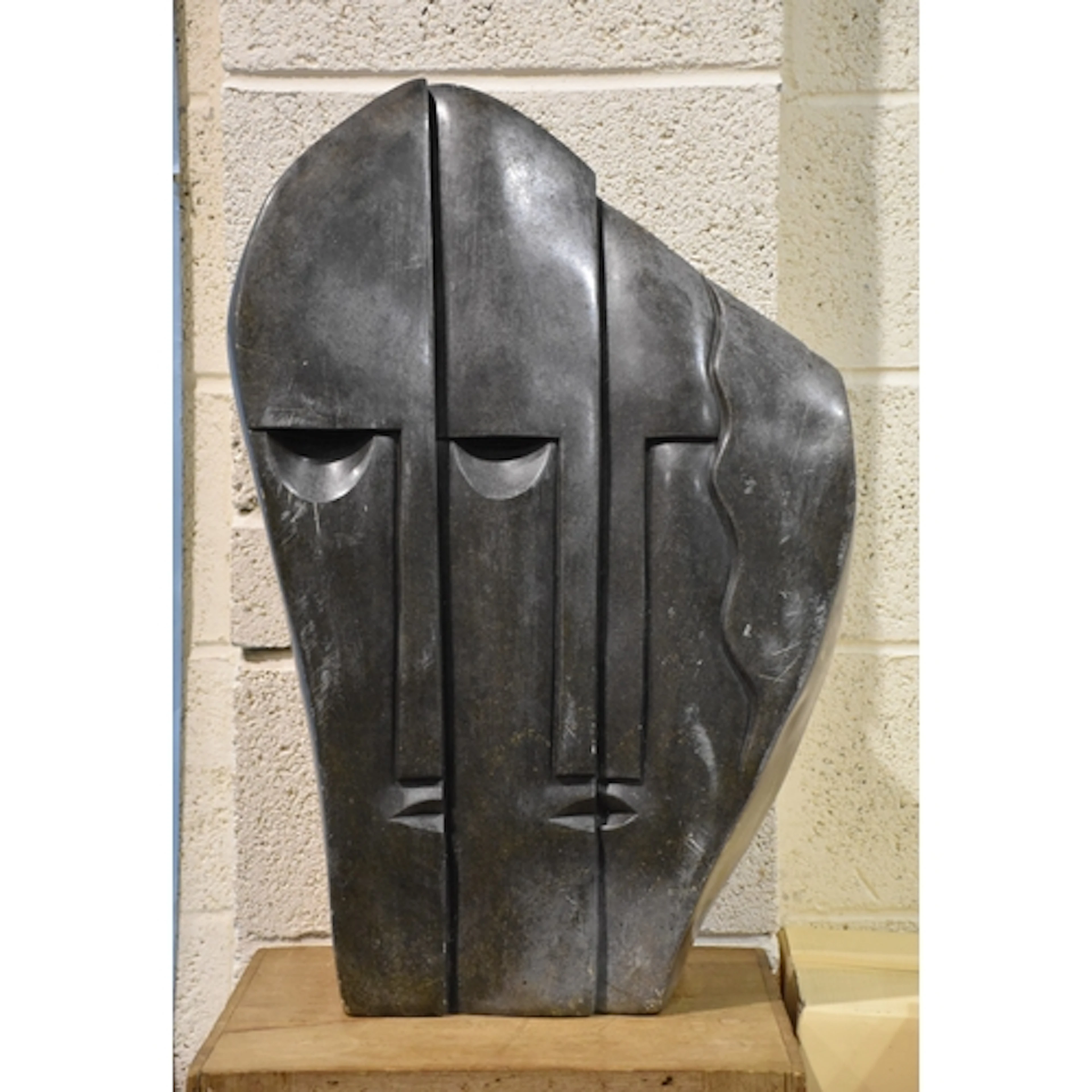 A large serpentine African figural carved sculpture, 69cm hi...