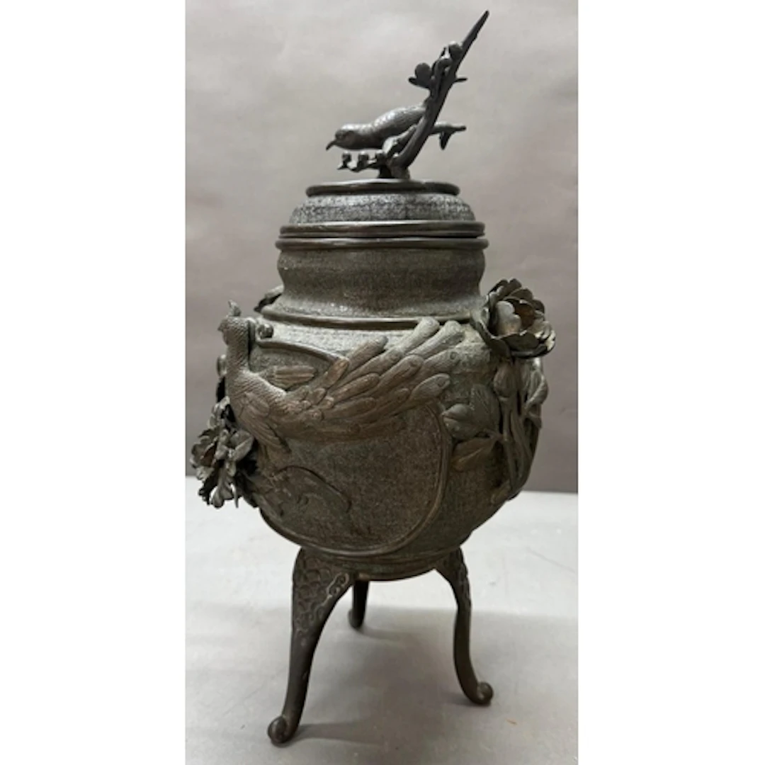 A Japanese bronze tripod incense burner with high bird and f...