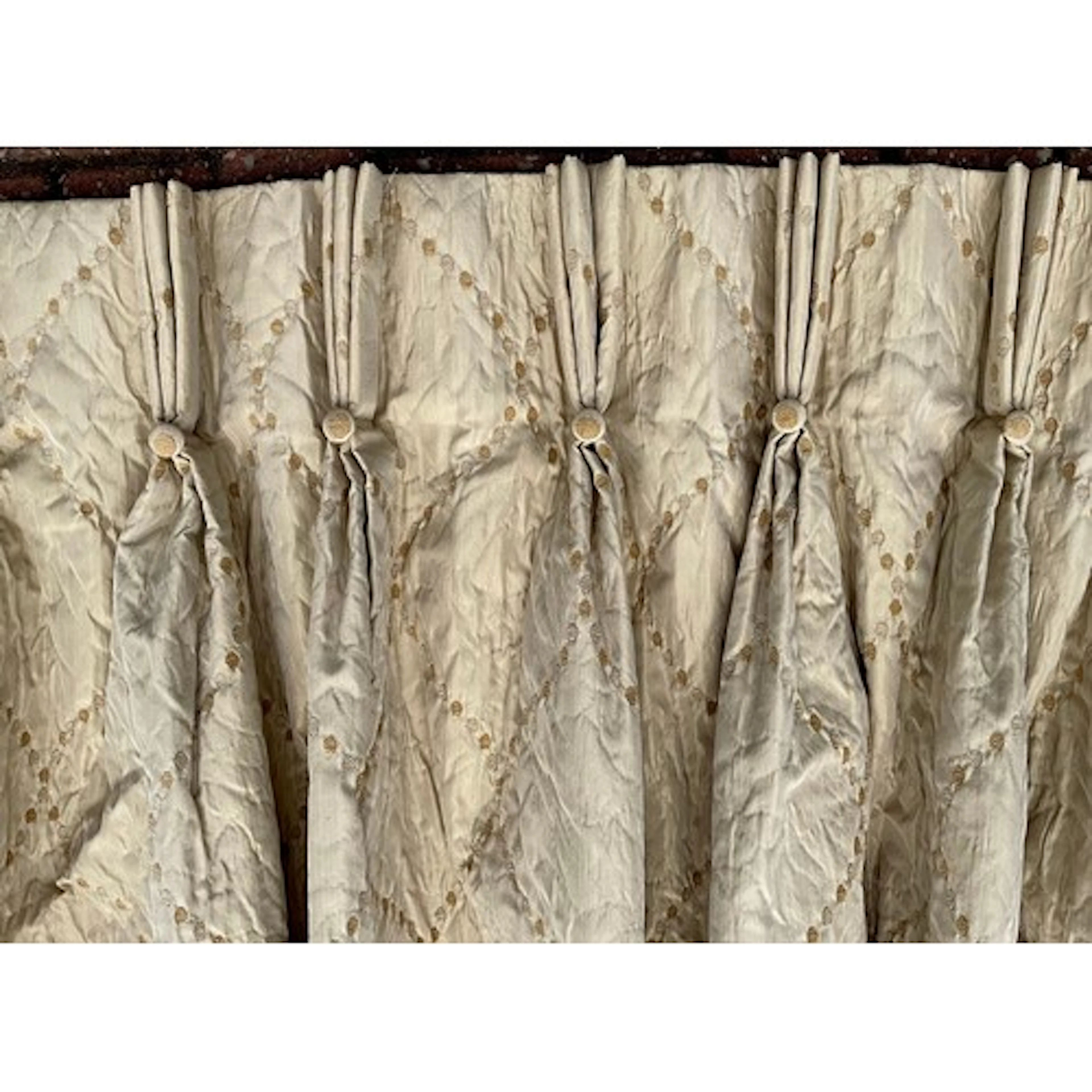 A suite of four silk blend champagne curtains, quilted textu...