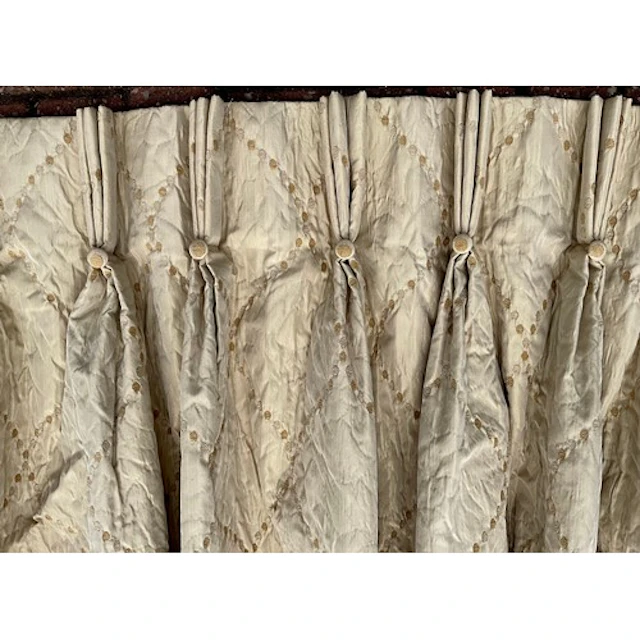 A suite of four silk blend champagne curtains, quilted textu...