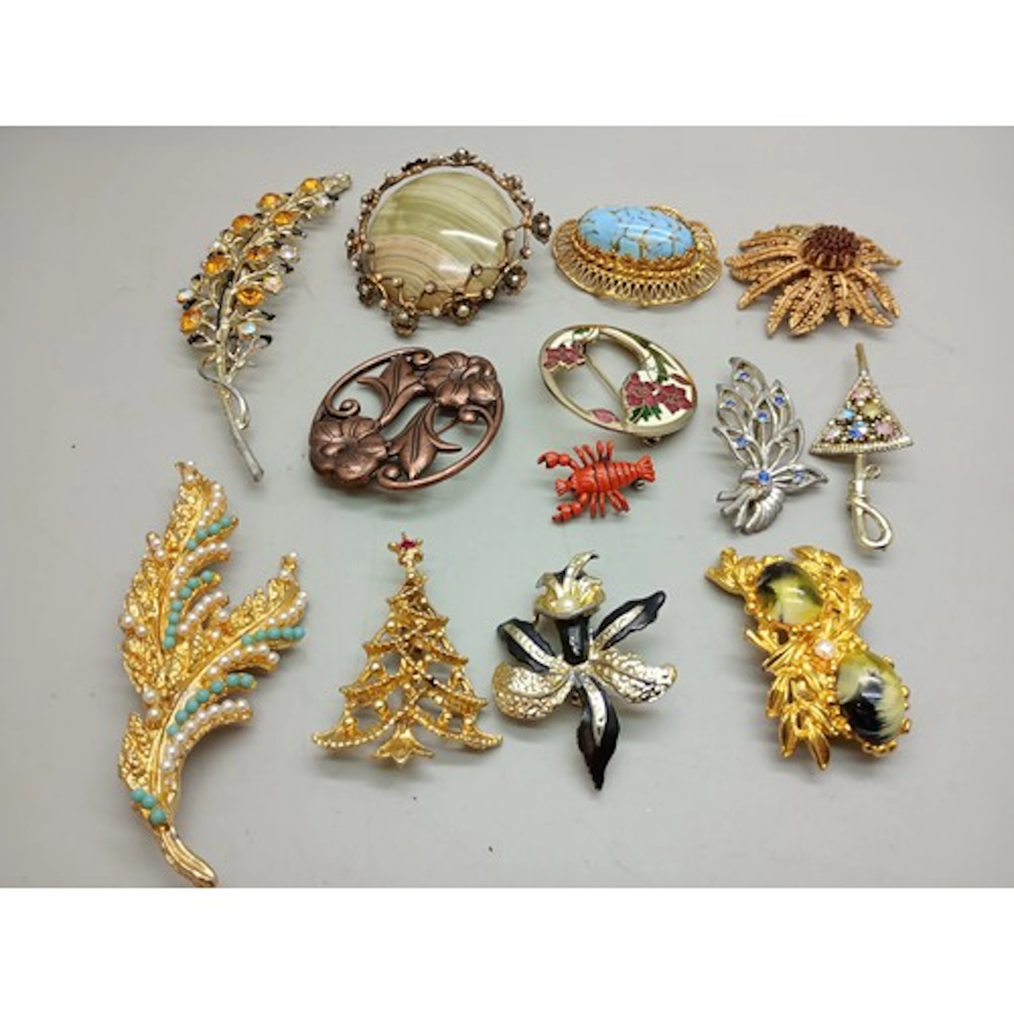 A collection of vintage and later costume brooches