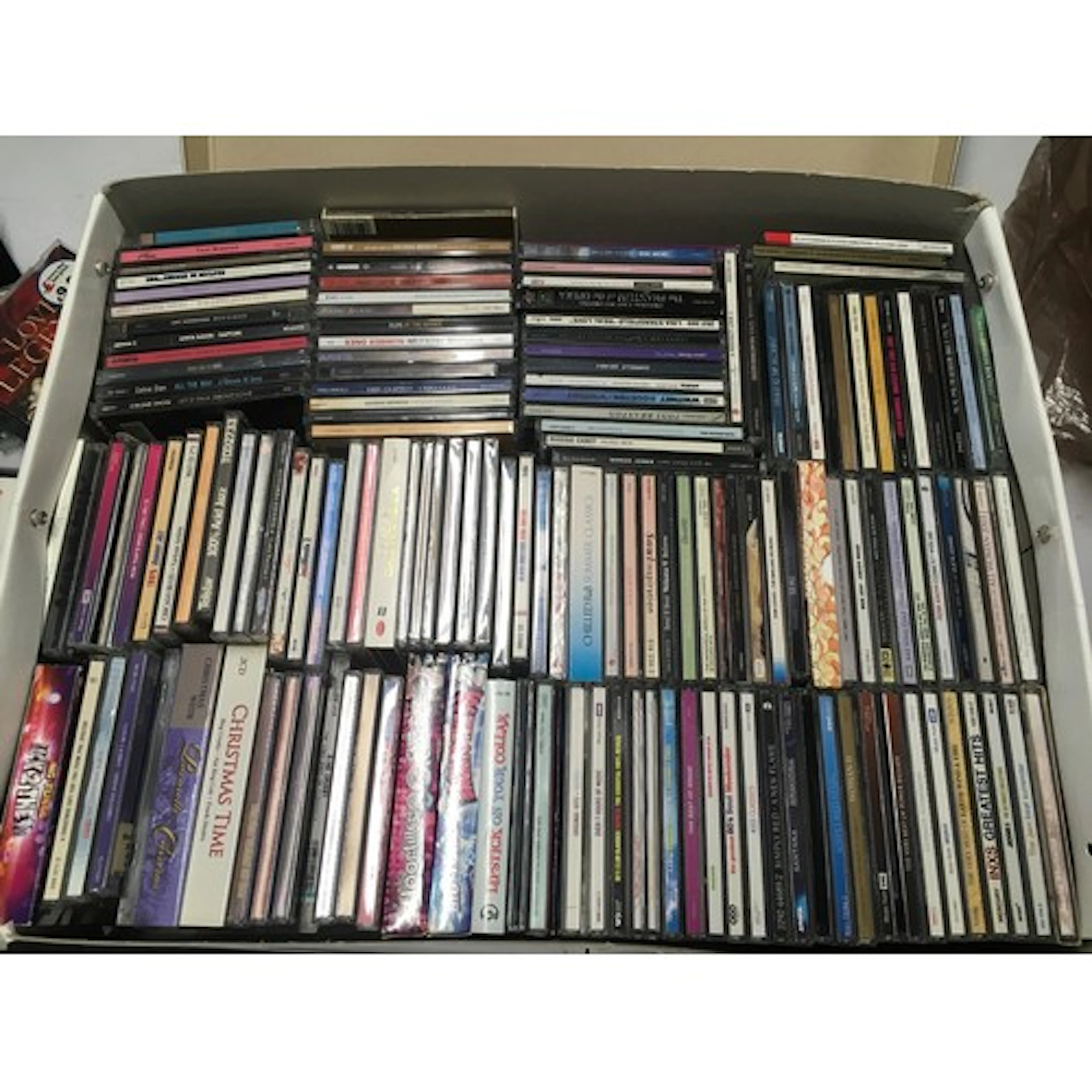 A box of CDs by various artists including Amy Winehouse, Mad...