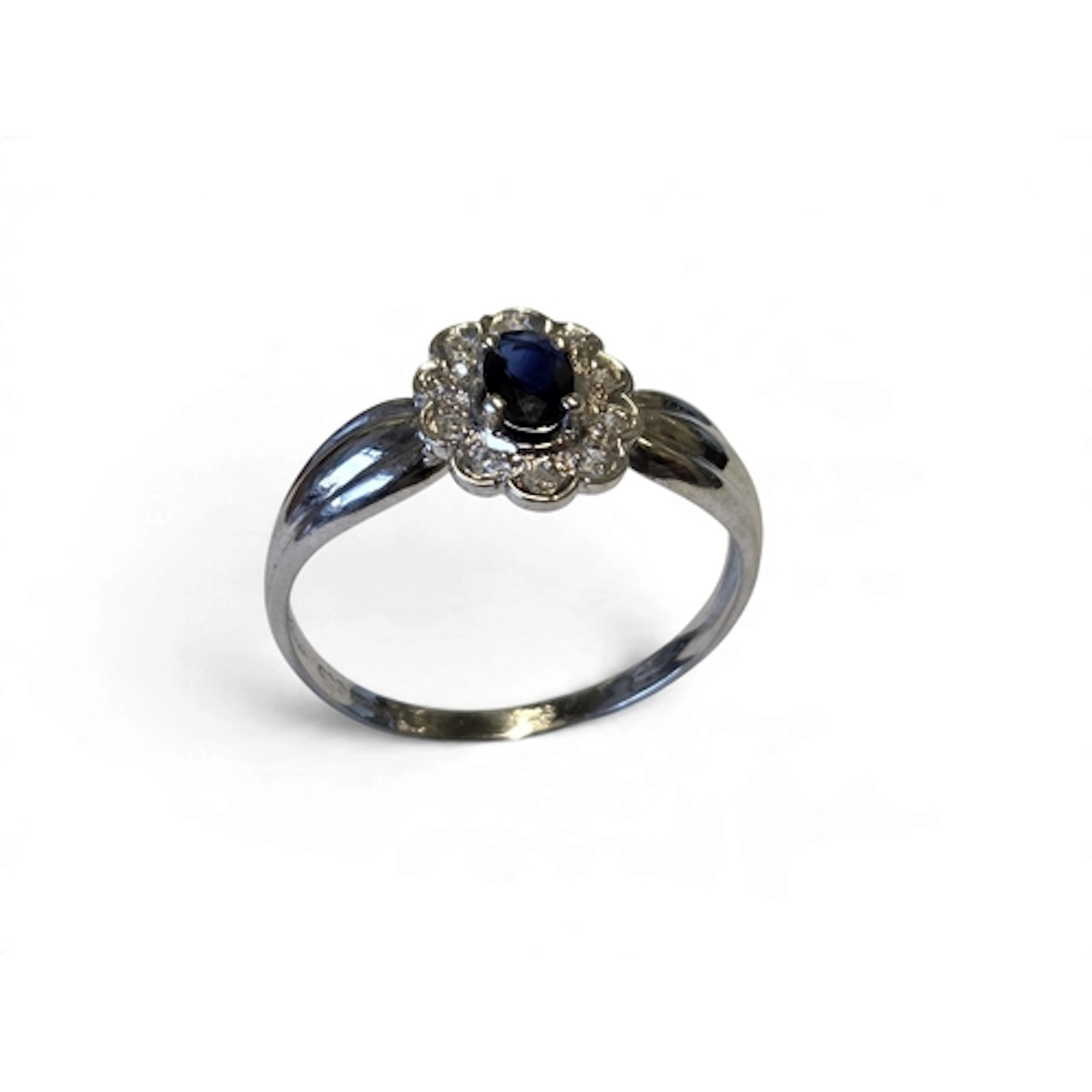 A good 18-carat white gold sapphire and diamond halo cluster...