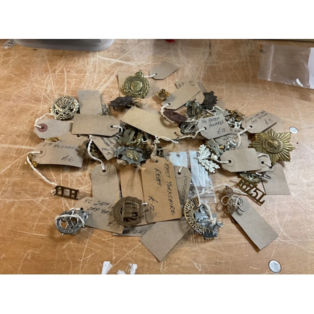 Large Qty of WWII cap badges.