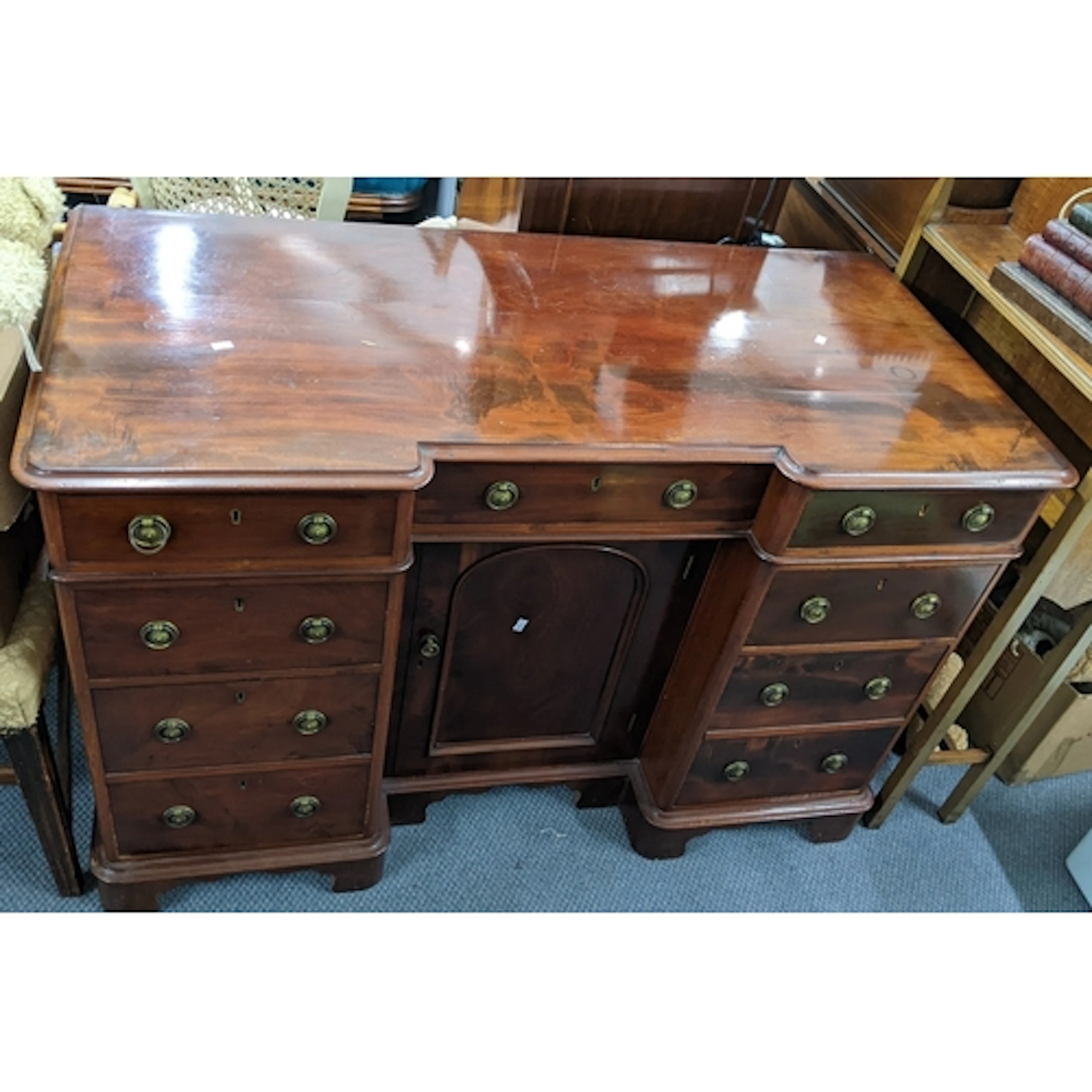 A 19th century mahogany desk having nine short drawers and a...