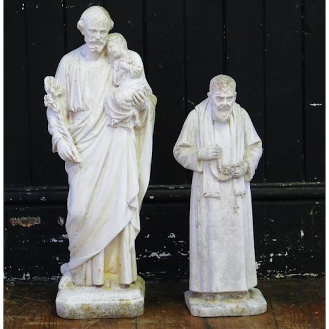 A carved hardstone figure of St Joseph, holding a young Jesu...