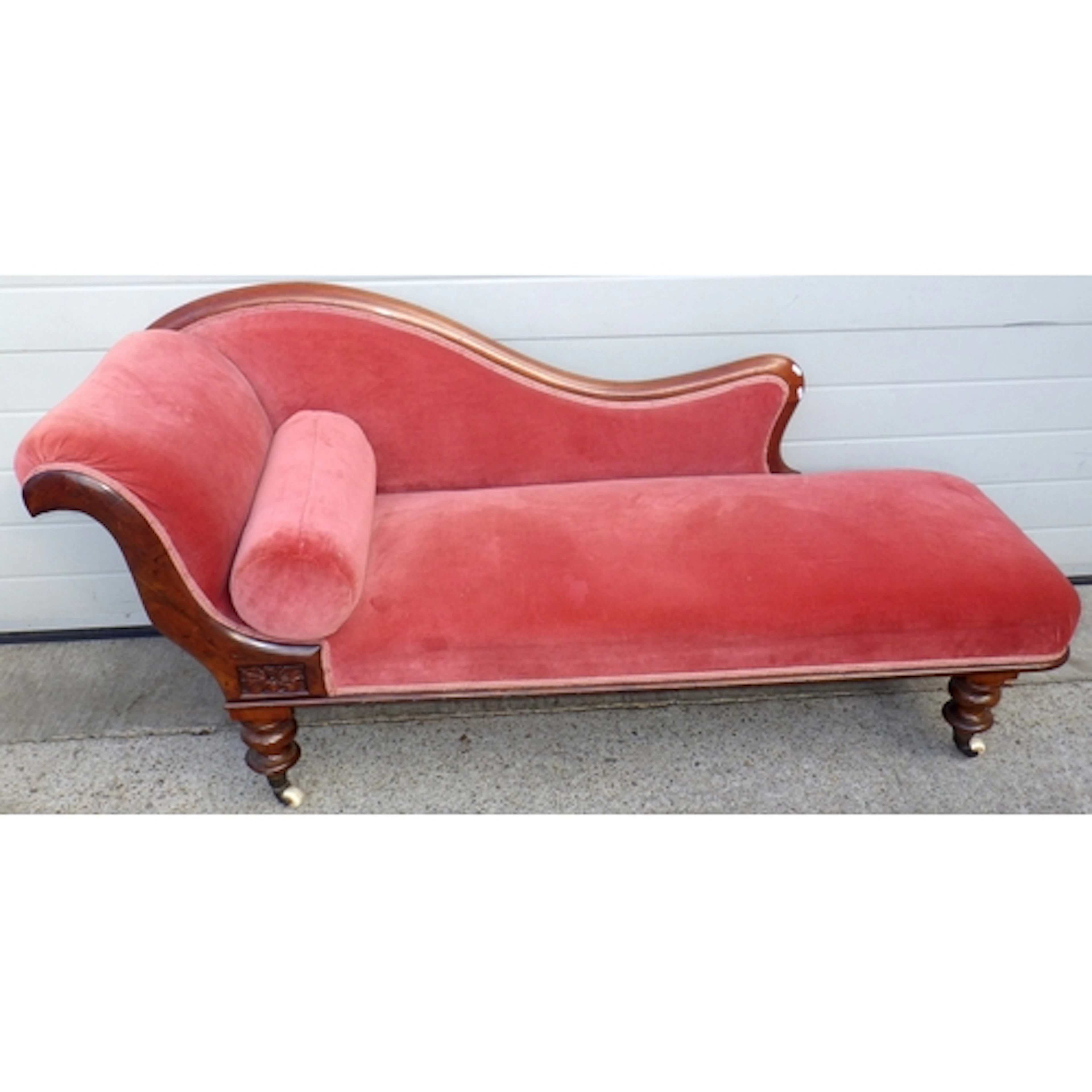 A pink upholstered chaise longue