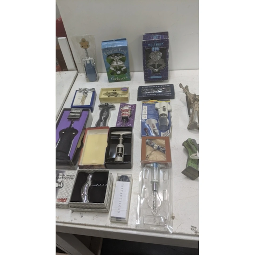 A collection of modern boxed novelty corkscrews, a Wallace a...
