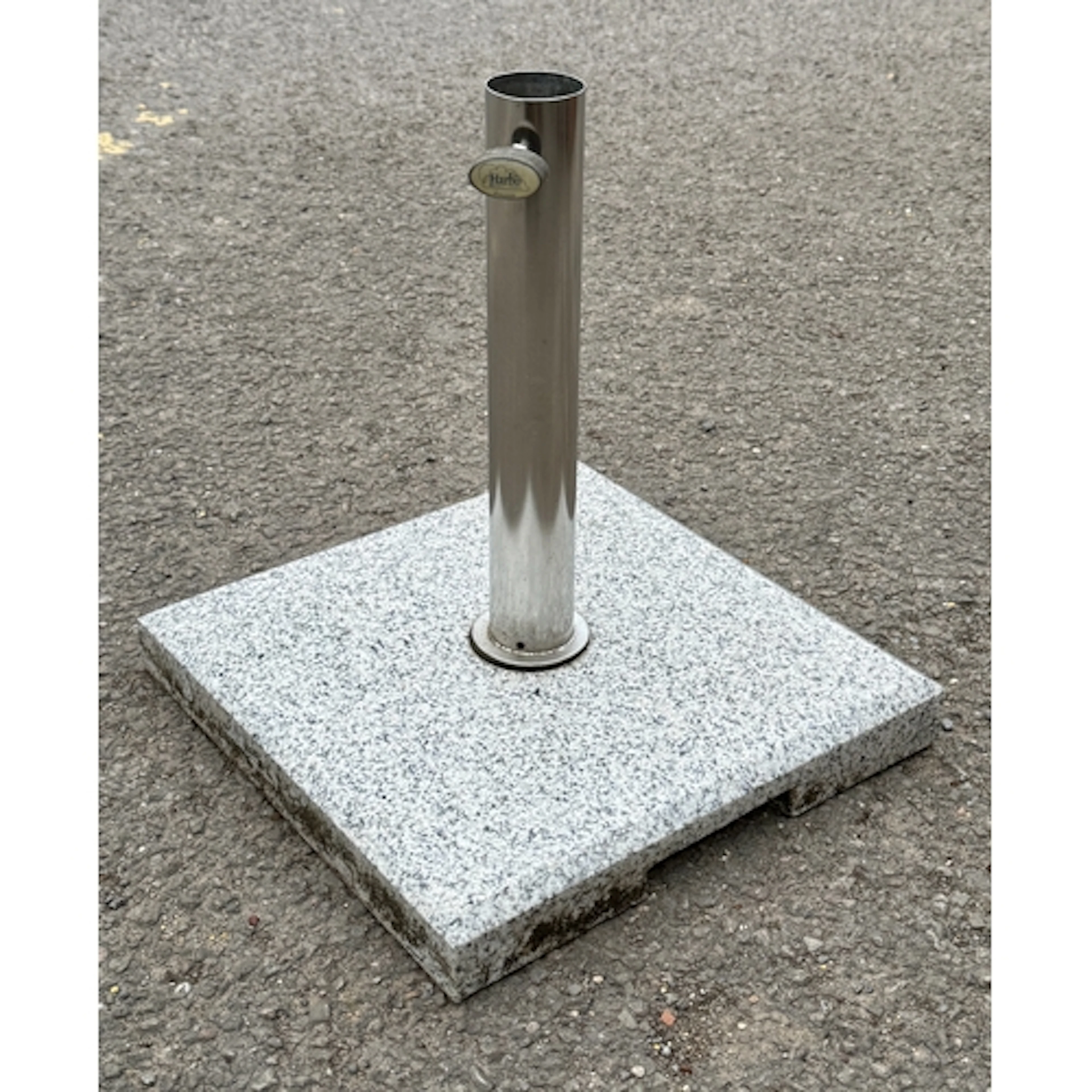 A granite and stainless steel garden parasol base by Harbo o...