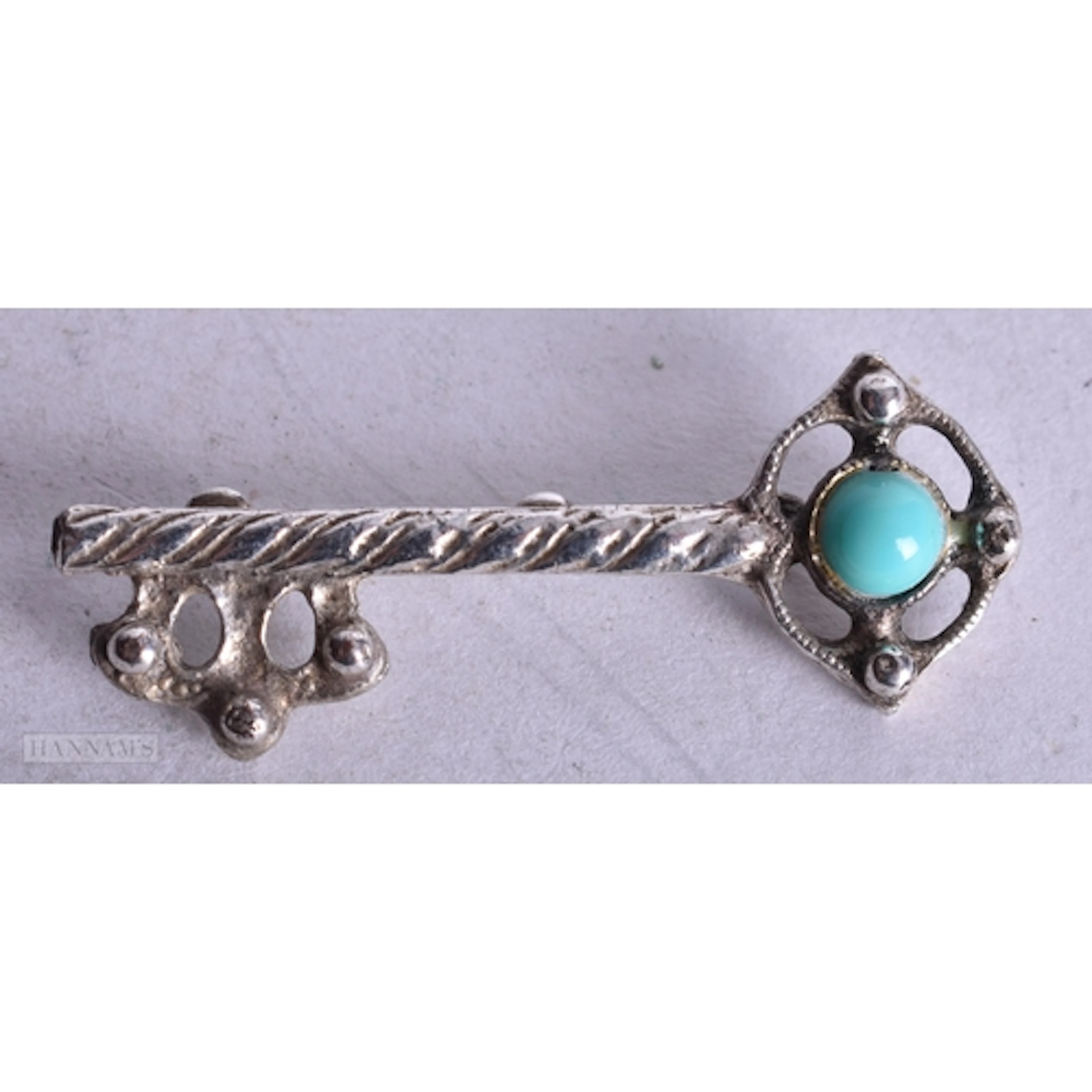 A BOXED WHITE METAL KEY BROOCH. 4.5 cm wide.