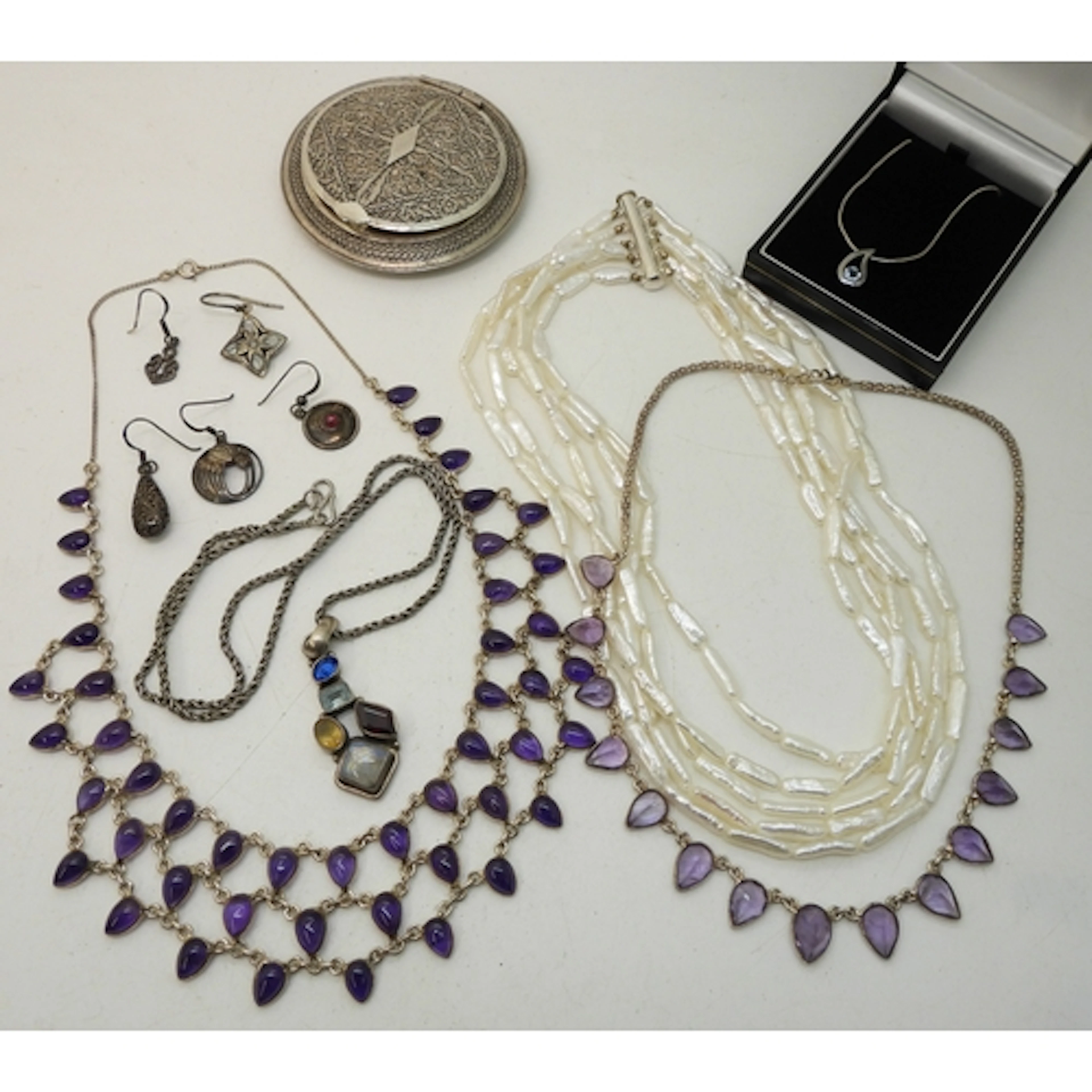 Two silver amethyst fringe necklaces, a triple string of biw...