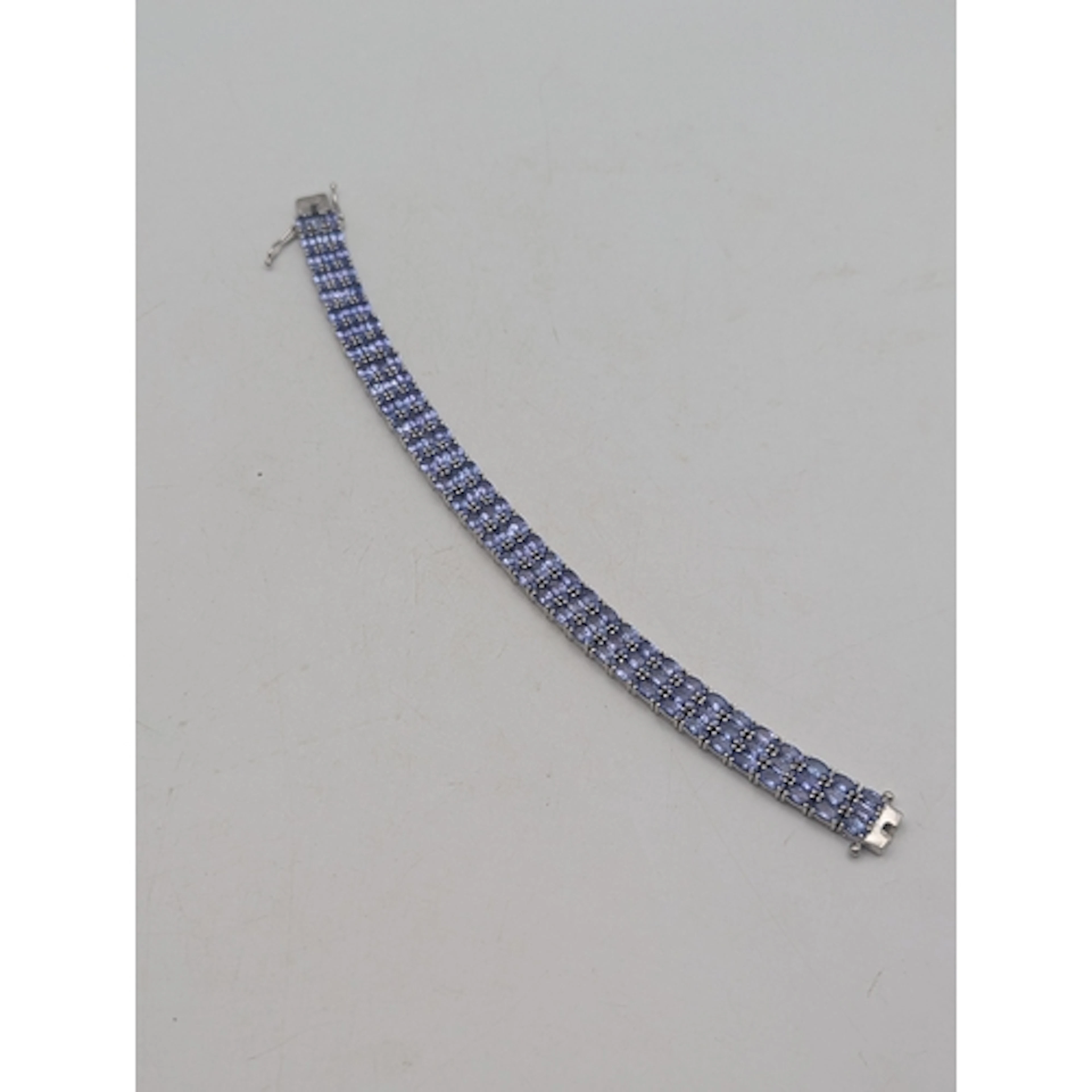 A silver and tanzanite multi-row tennis bracelet, featuring ...