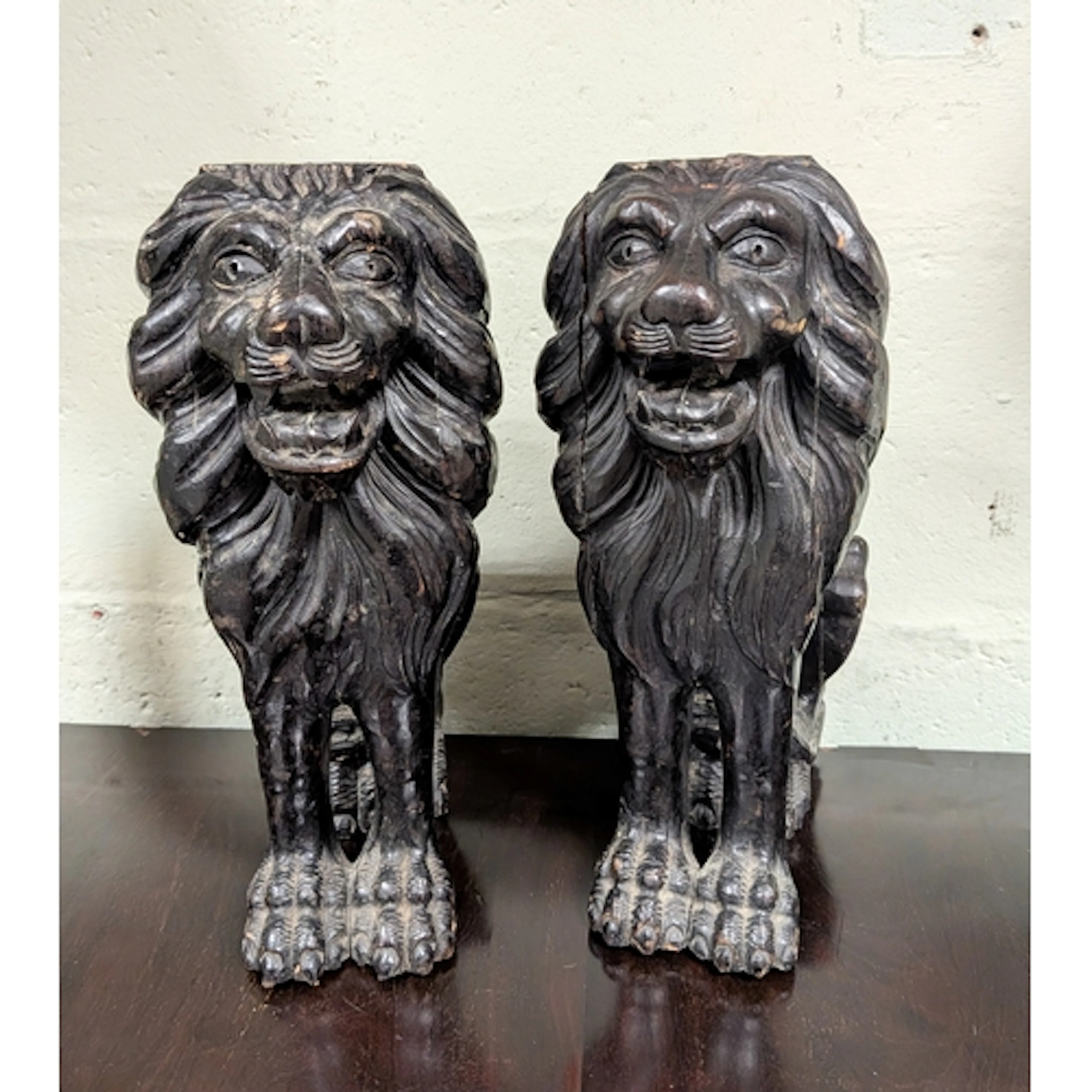 A pair of carved hardwood lion bracket supports or bases, 13...