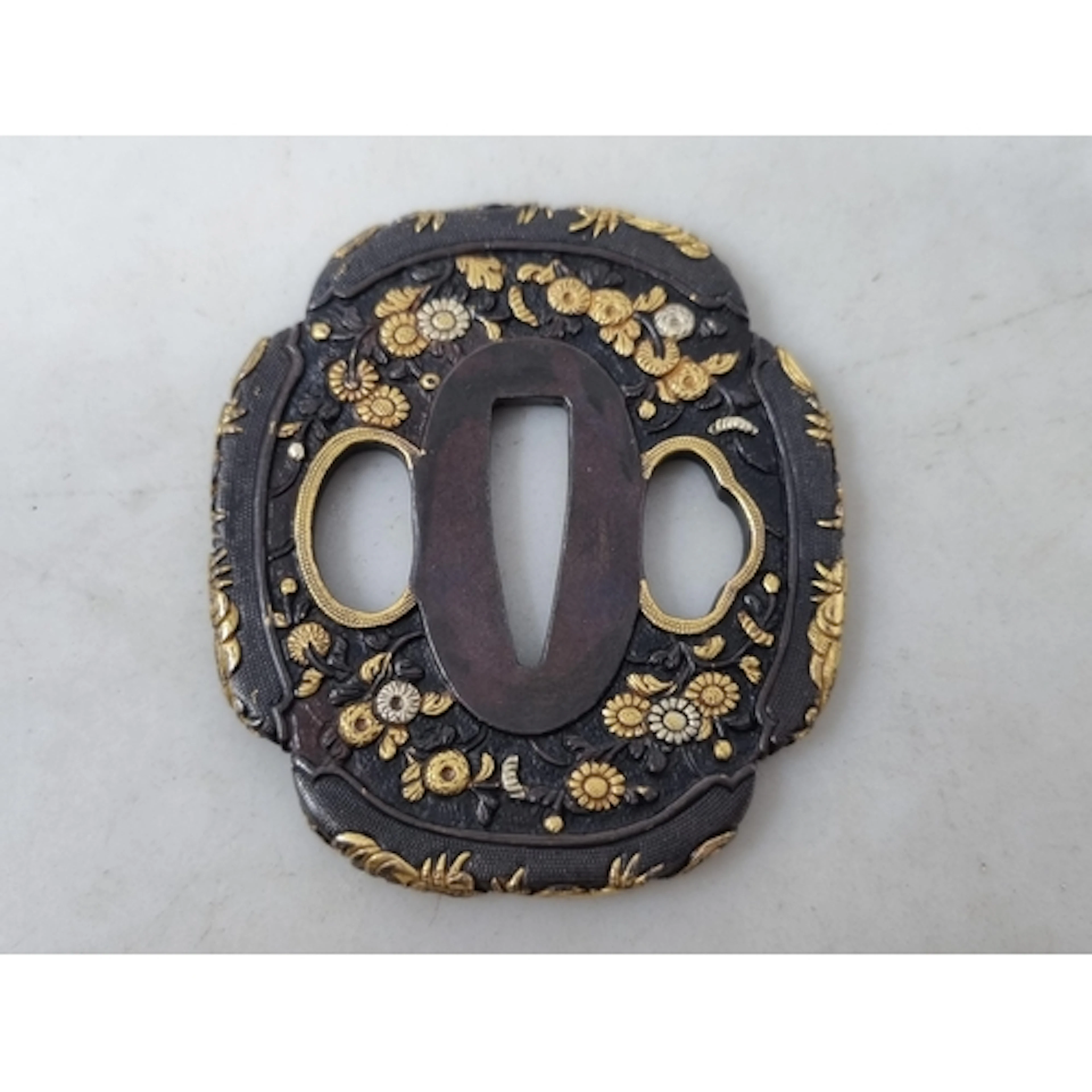 A Shakudo Tsuba - 2 1/4" x 2 1/2" late Edo. Carved with a pr...