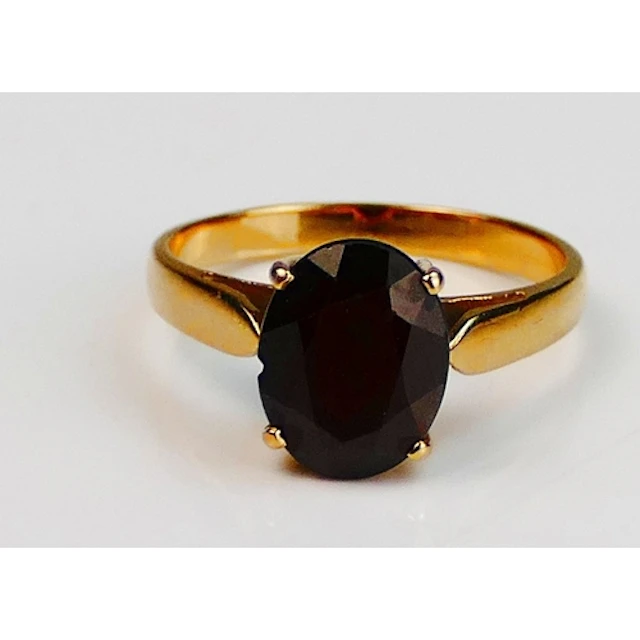A garnet ring in a 14ct yellow gold setting, 10.3x8mm stone,...