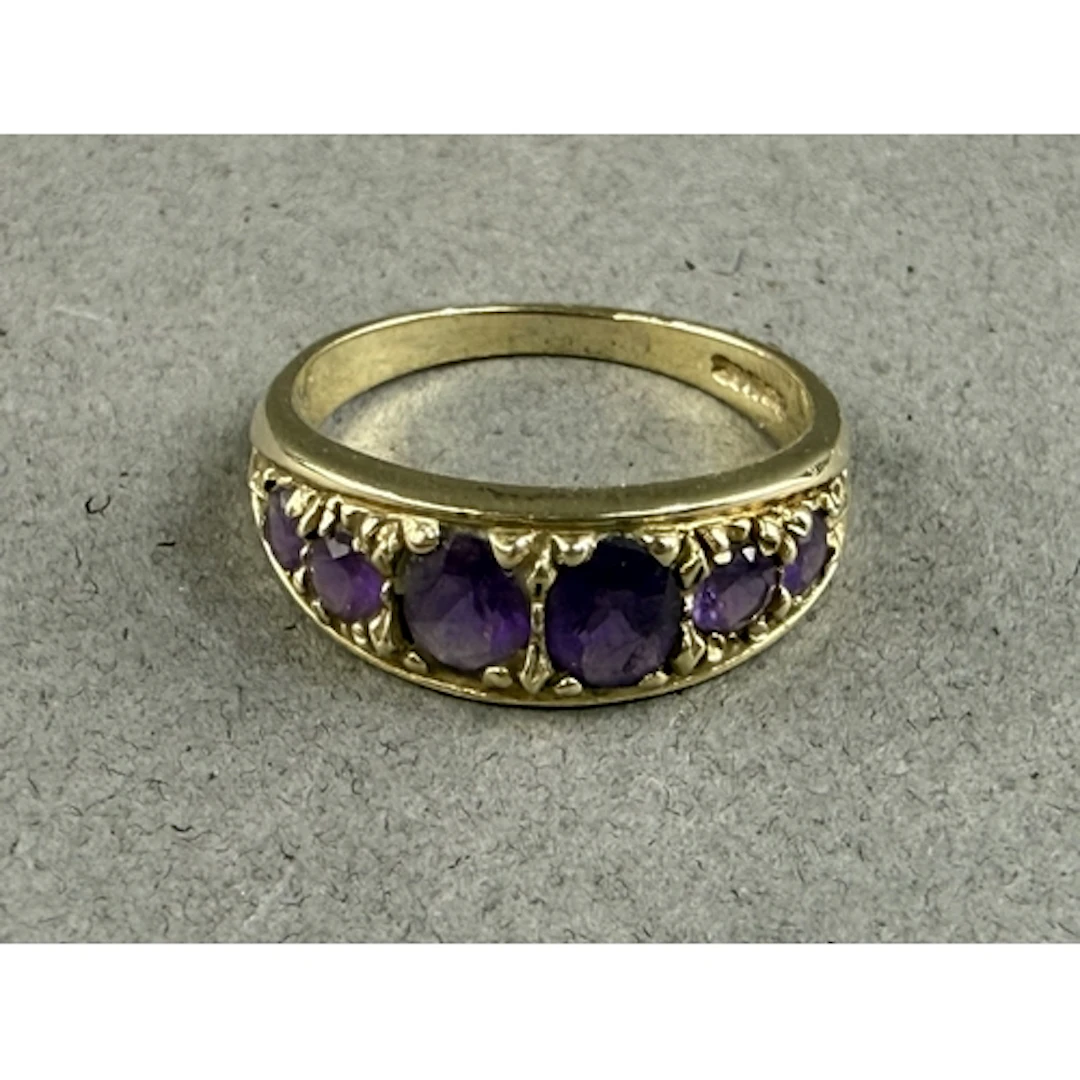Jewellery: a 9ct yellow gold ring set with six graduated ame...
