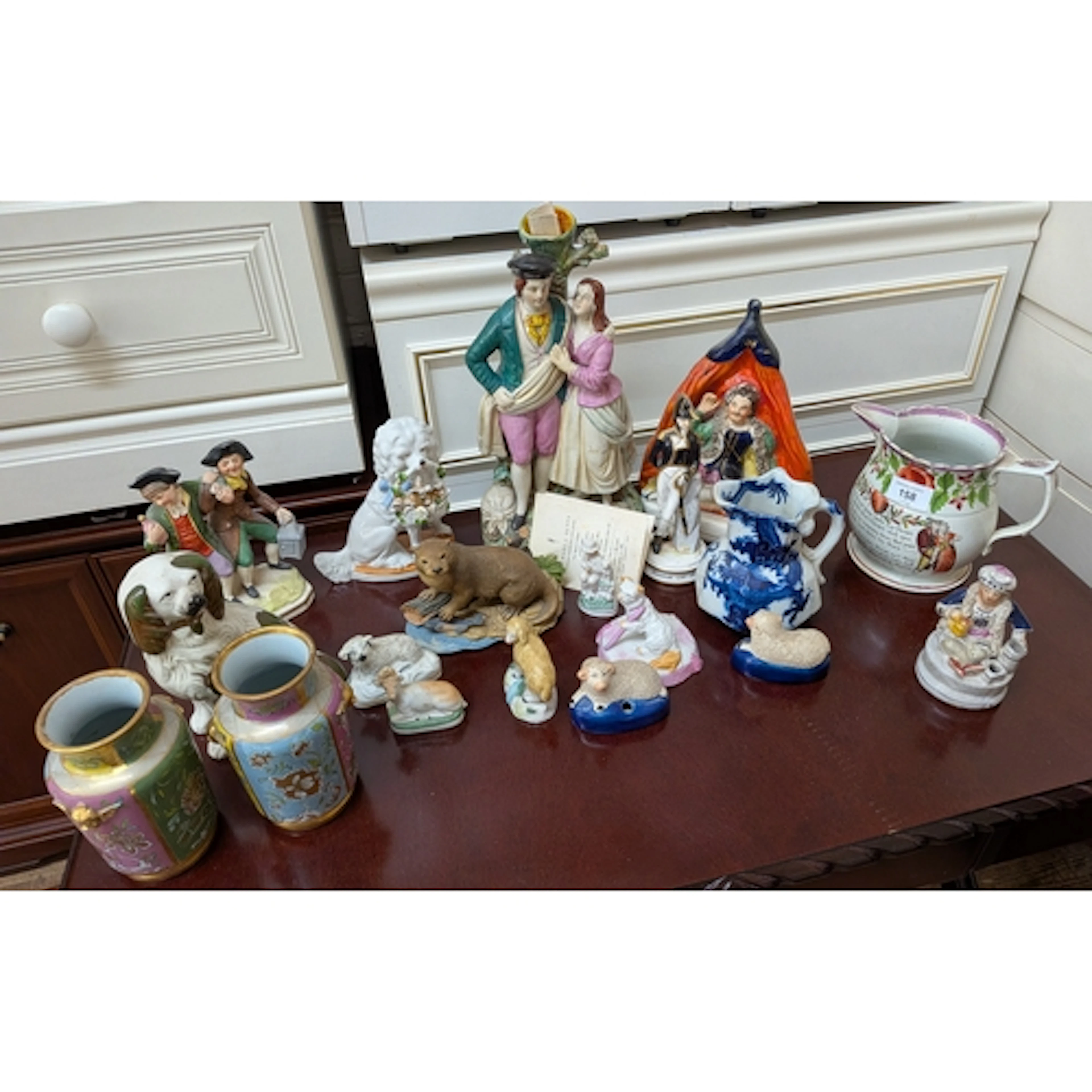 A Sunderland lustre jug and several Staffordshire figurines...