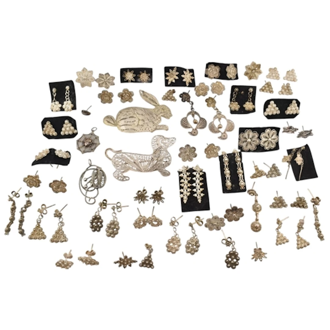 Collection of silver and white metal filigree earrings and b...