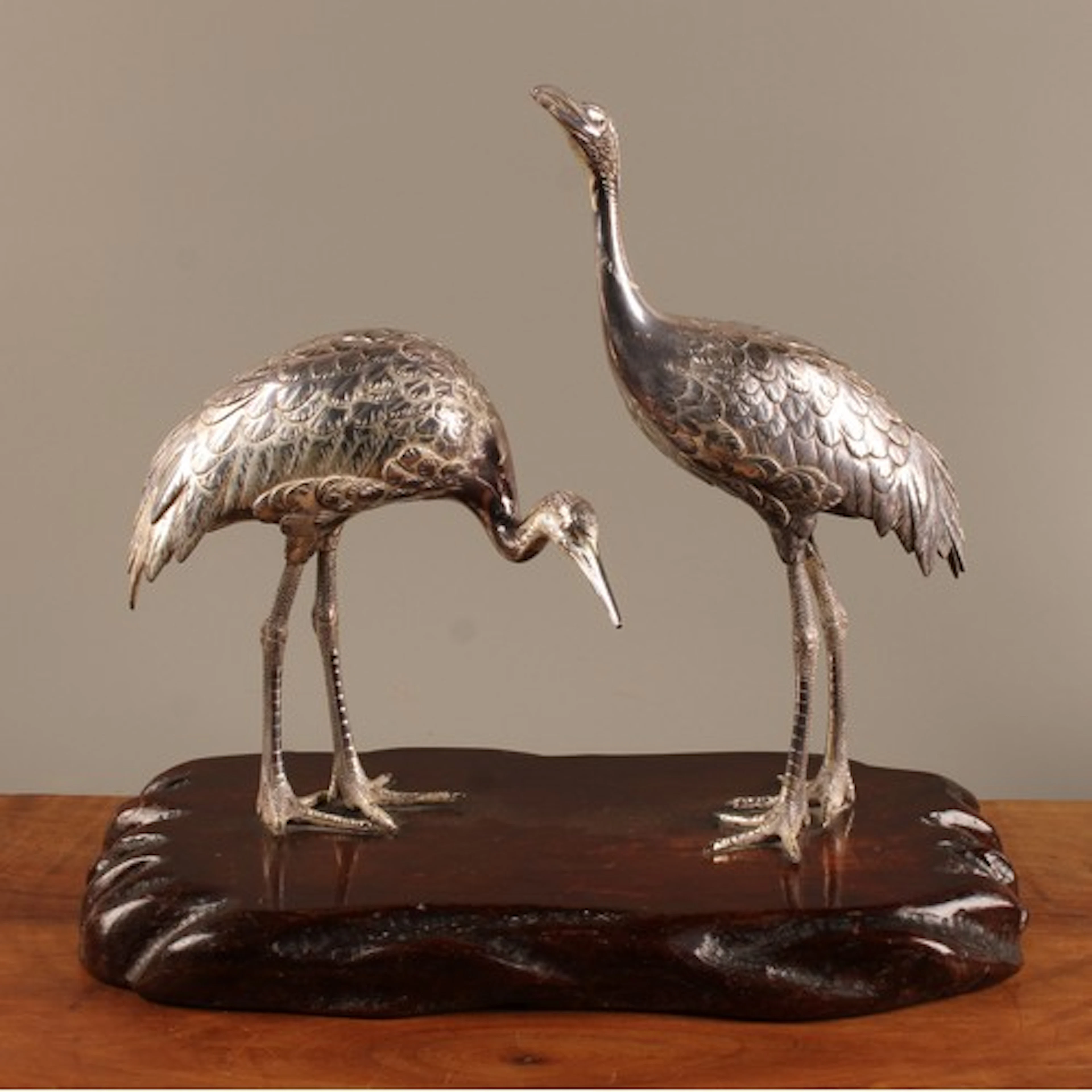 A pair of Japanese silver models, of cranes, naturalisticall...