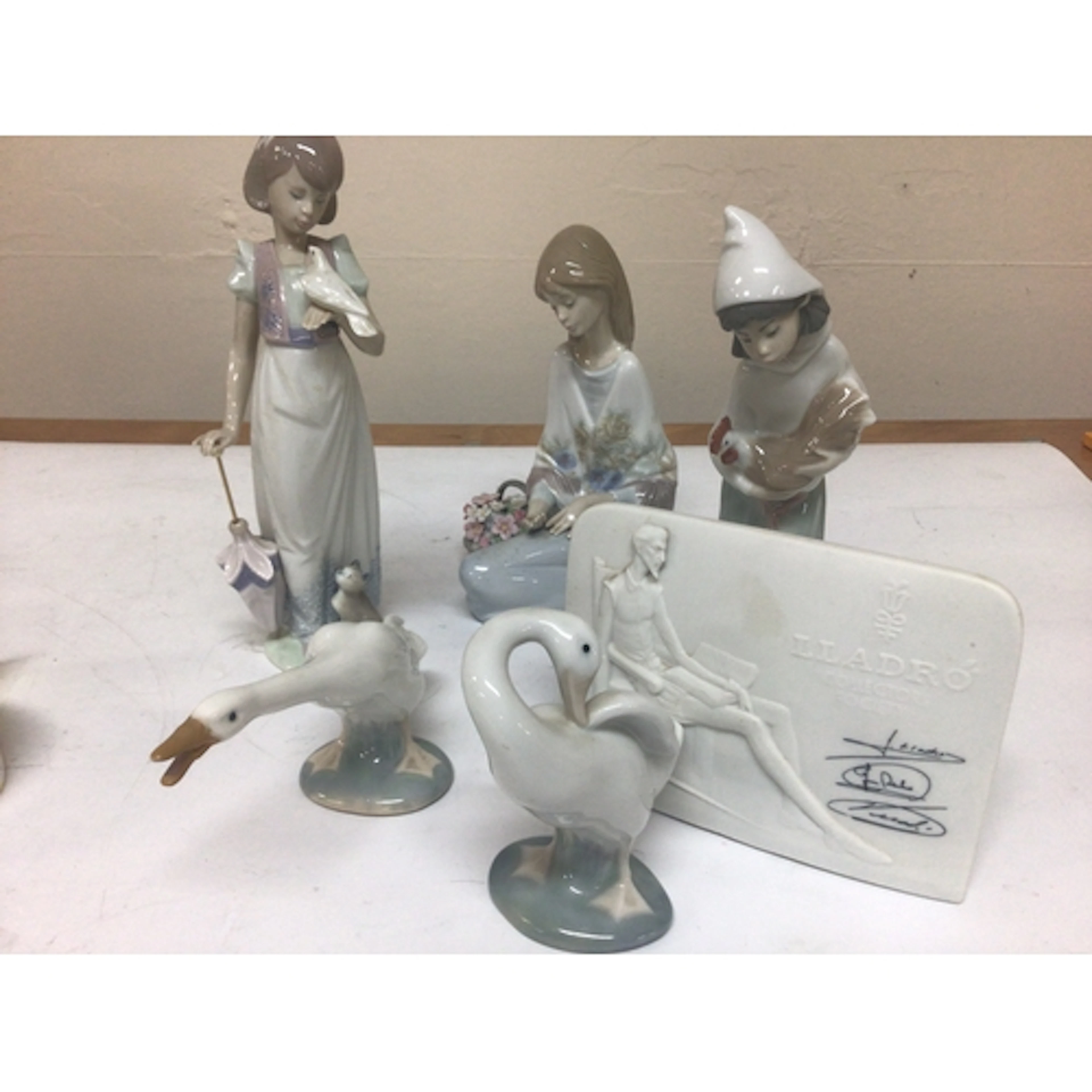 A collection of Lladro figures in the form of children...
