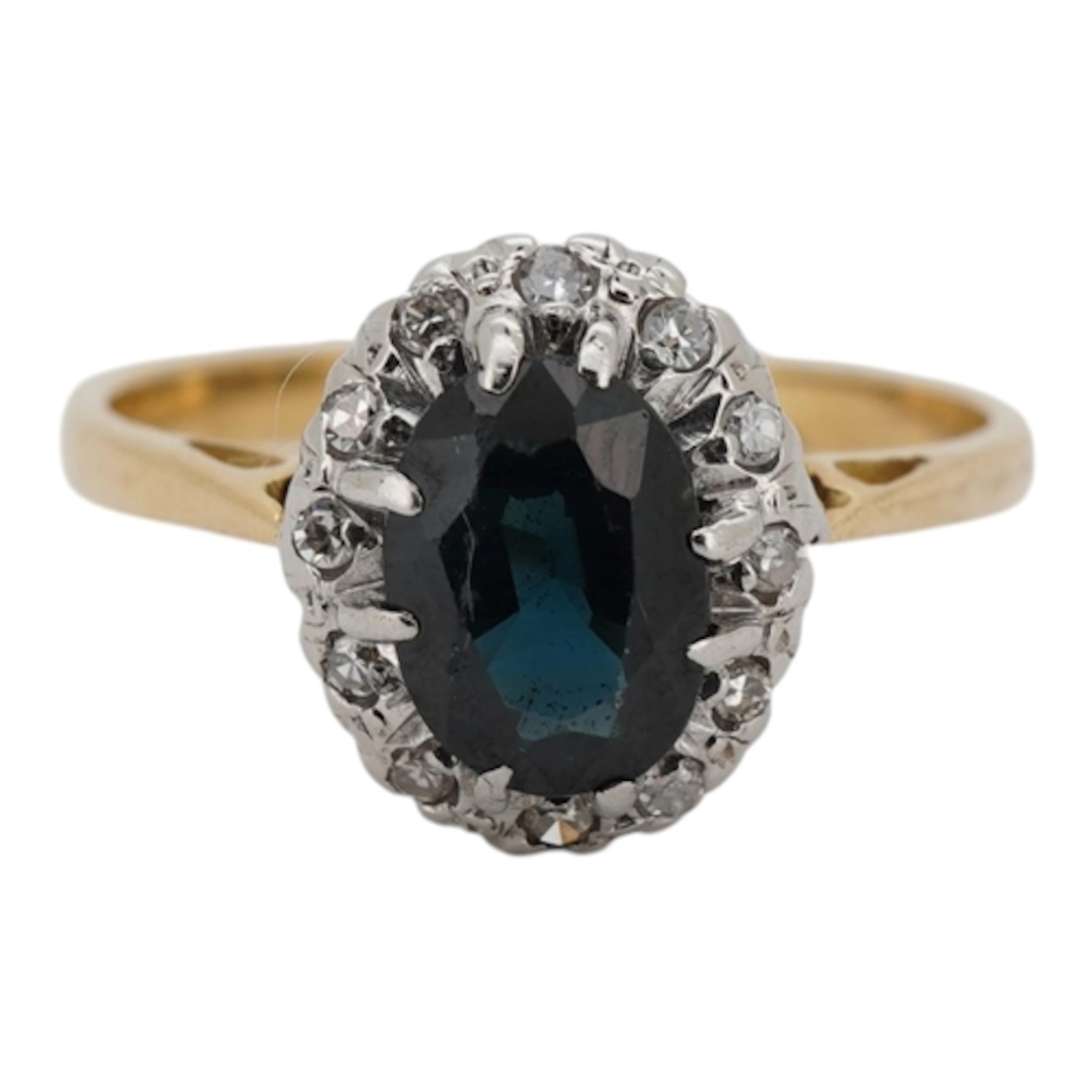 A sapphire and diamond ring, claw-set with an oval sapphire ...